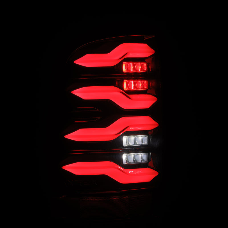 AlphaRex Luxx-Series LED tail lights for 09-18 Dodge Ram, featuring black housing, activation light, and sequential signal.