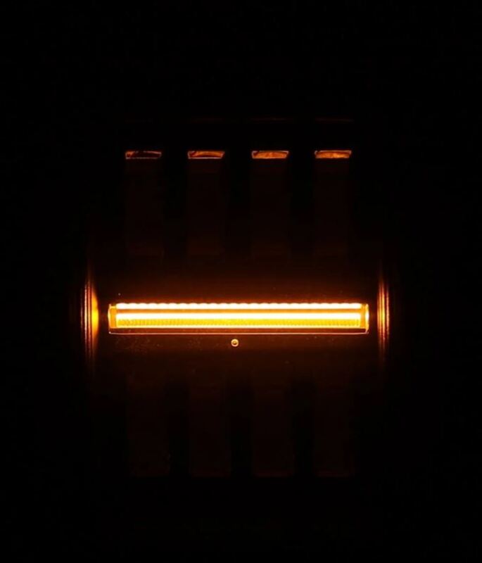AlphaRex Jeep Gladiator JT Nova-Series prismatic LED tail light in chrome, showcasing a bright orange illumination.