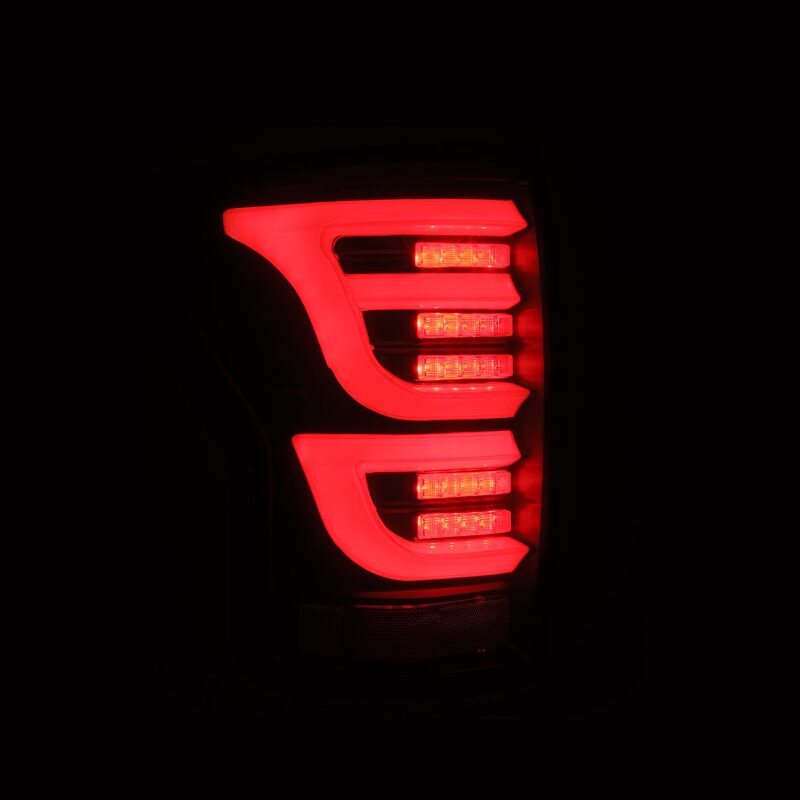 AlphaRex LUXX-Series LED tail lights for 07-13 Toyota Tundra in black, featuring a sleek design and bright red illumination.