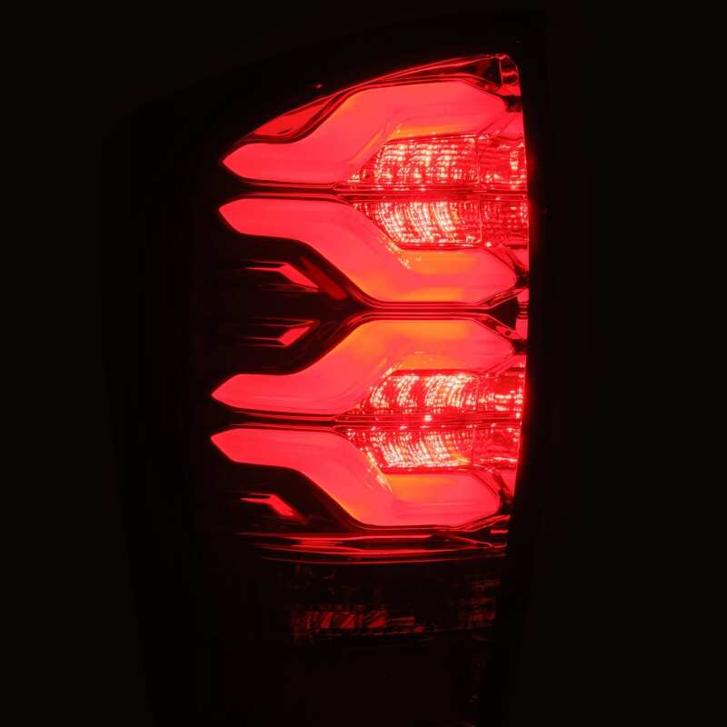 AlphaRex LUXX LED taillights for 16-21 Toyota Tacoma in black and red with sequential signal and activation light.