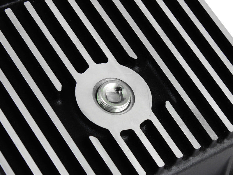 aFe POWER transmission pan for Ford trucks 80-92 featuring a sleek design with cooling fins and a drain plug.