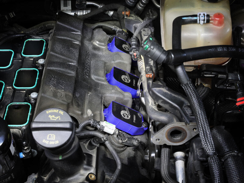 afe SCORCHER ignition coils installed in a Dodge/Jeep/RAM engine, enhancing performance for V6-3.6L models from 2016 to 2025.
