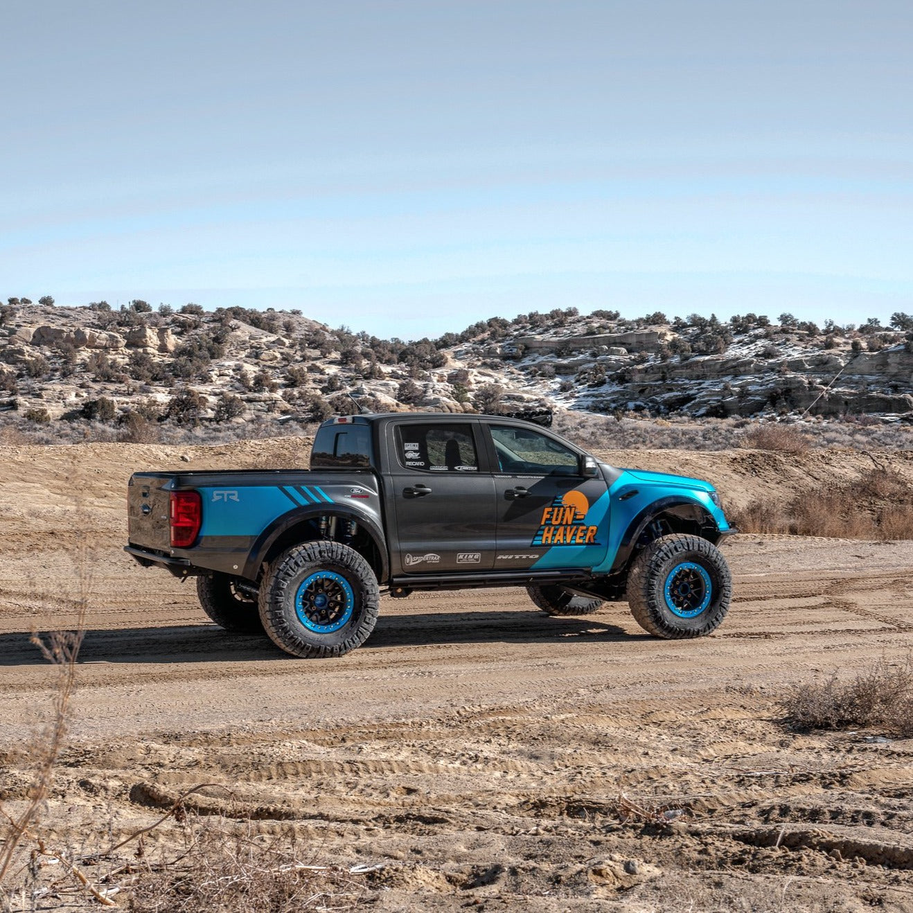 2019-2023 Ford Ranger with custom bedsides, showcasing offroad capabilities in a rugged outdoor setting.