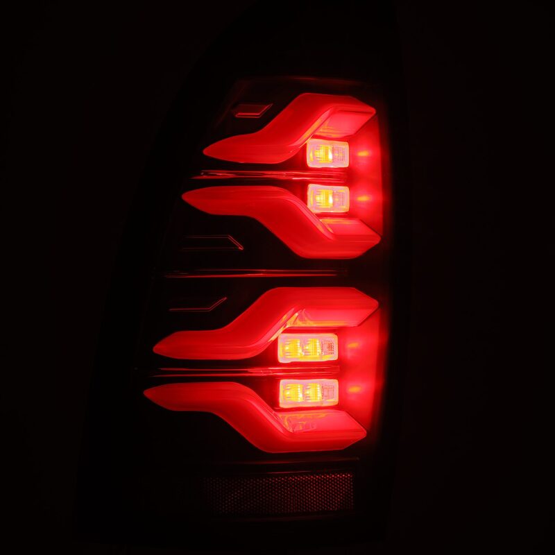 AlphaRex LUXX LED taillights for 05-15 Toyota Tacoma in black, featuring sequential signals and active lighting.