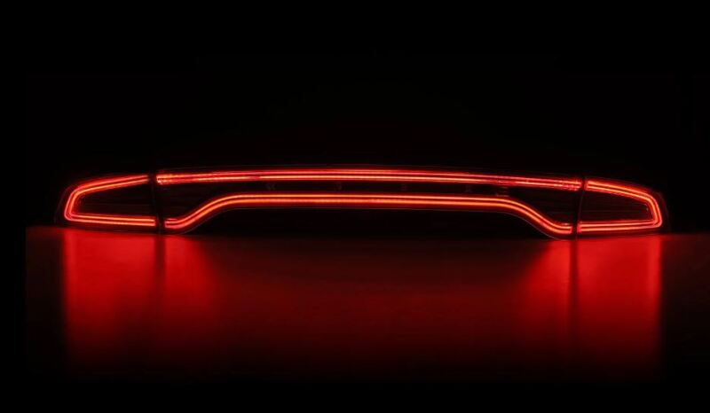 AlphaRex NOVA-Series prismatic LED tail lights for 2015-2023 Dodge Charger in smoke finish, featuring a sleek red illumination.