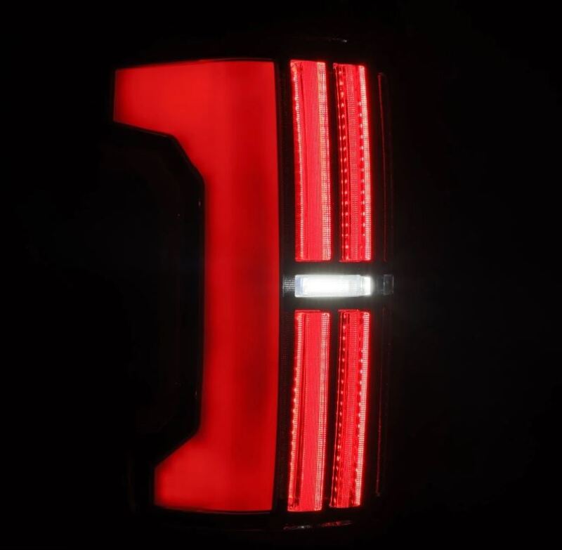 AlphaRex 07-13 Toyota Tundra Nova-Series LED tail lights in Alpha-Black, featuring a sleek design with bright red illumination.