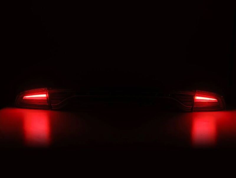 AlphaRex NOVA-Series prismatic LED tail lights for 2015-2023 Dodge Charger in black, showcasing bright red illumination.