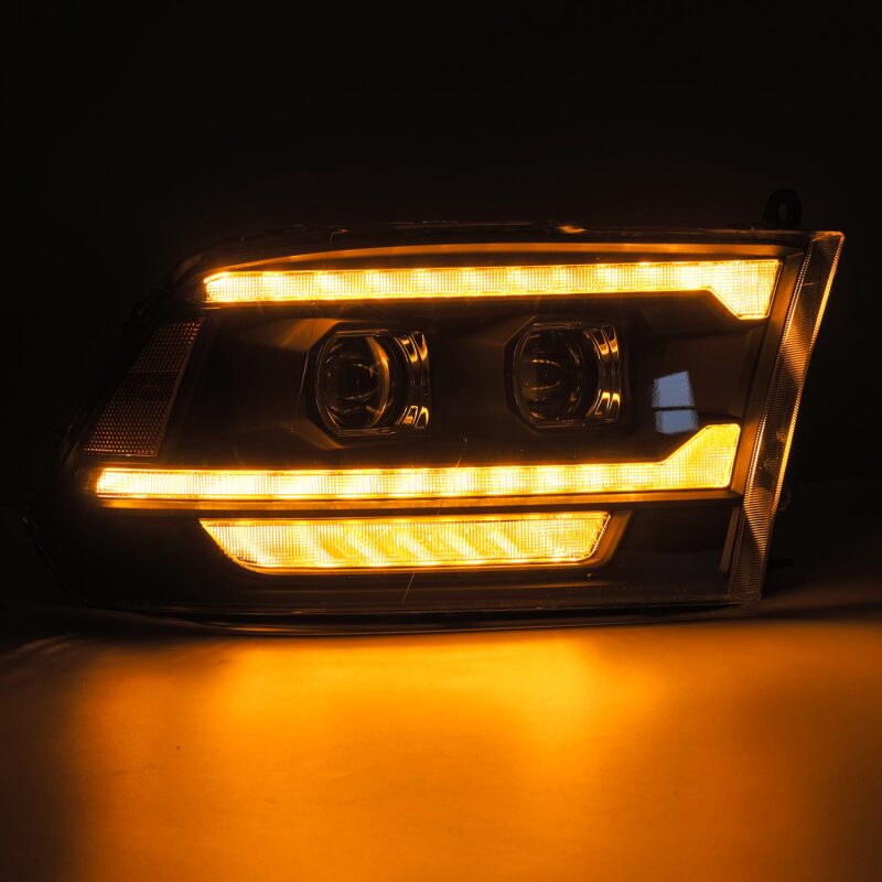 AlphaRex PRO-Series projector headlights for 09-18 Ram 1500/2500 with black housing, sequential signals, and DRL.