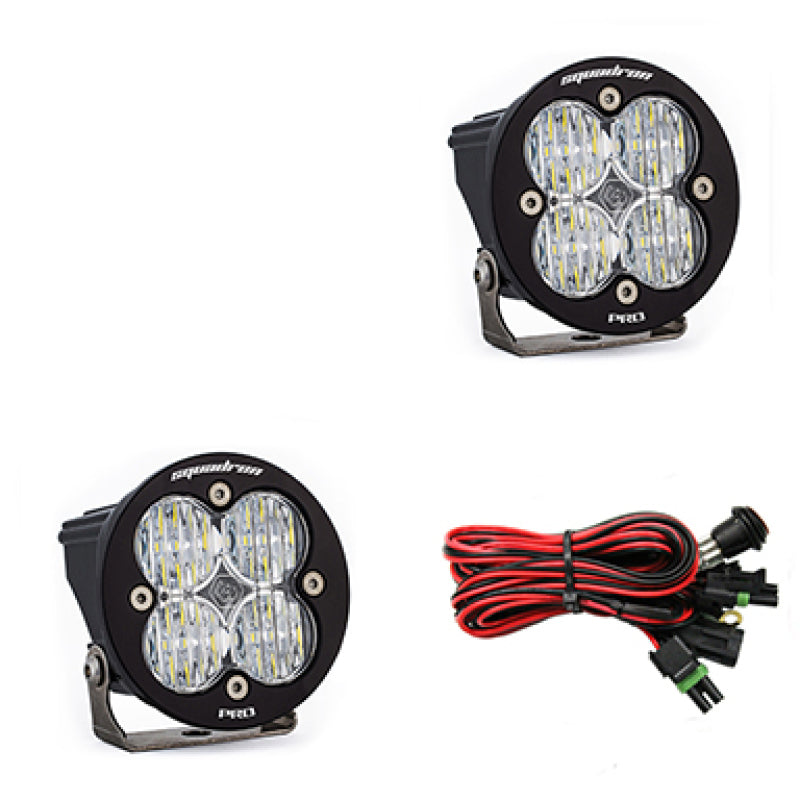 Baja Designs Squadron R Pro Wide Cornering Pair LED light pods with clear lenses and wiring harness for offroad vehicles.