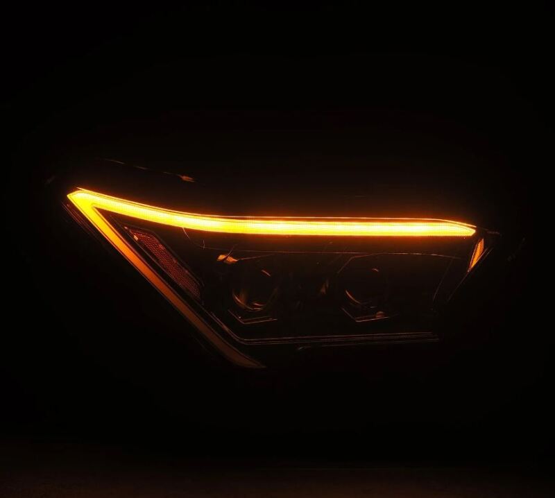 AlphaRex 2024 Toyota Tacoma LUXX-Series projector headlights with a sleek design and bright amber LED accents.