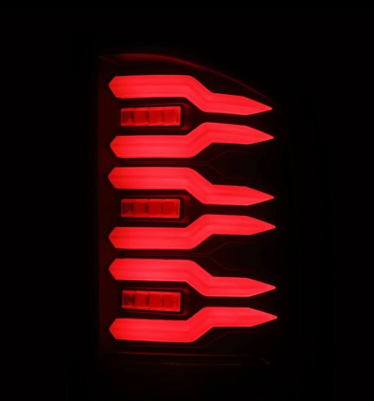 AlphaRex Luxx-Series LED tail lights for 07-14 Chevrolet Silverado with black housing and smoked lens, illuminated design.