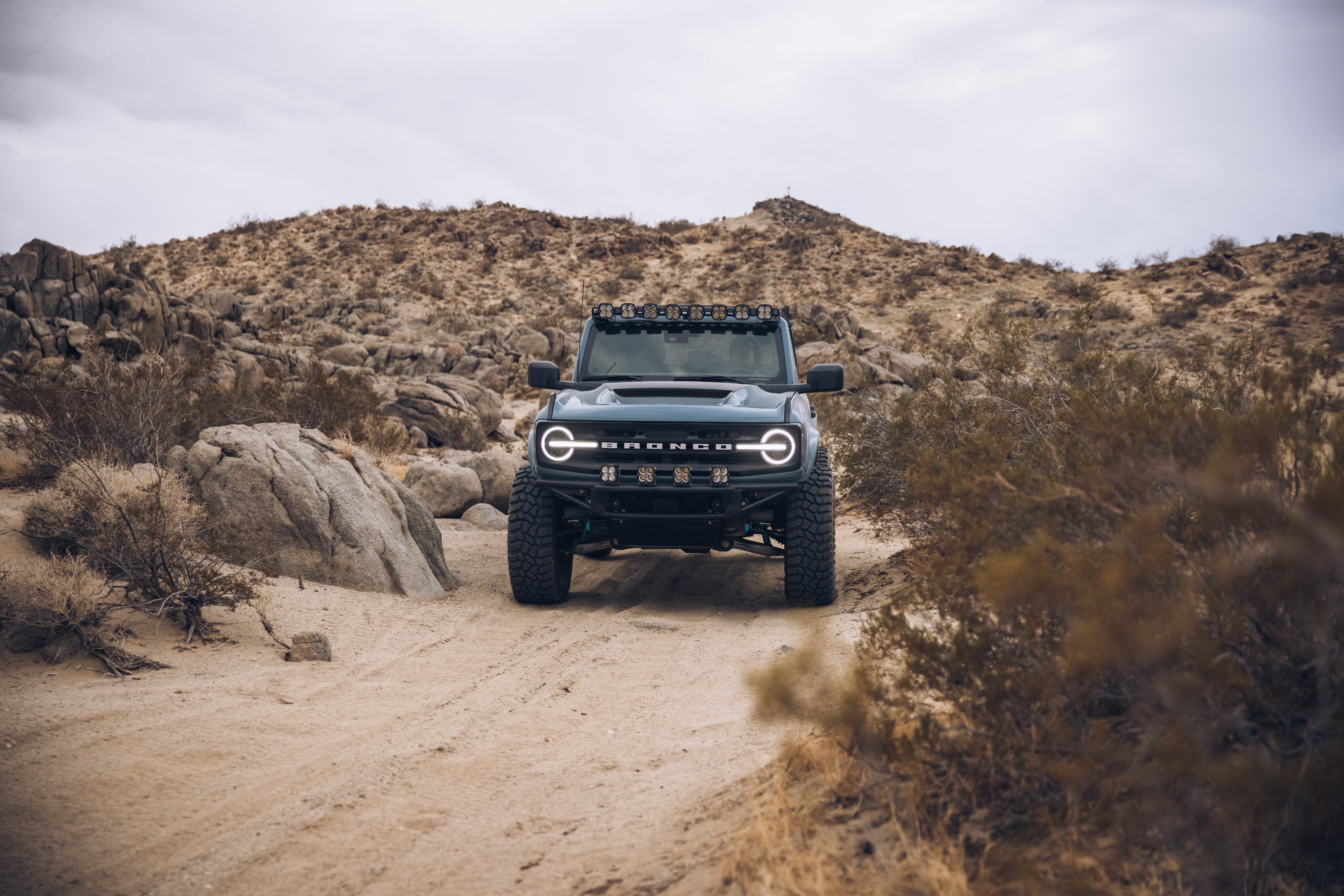 ADV Fiberglass 2021 Ford Bronco on a rugged off-road trail, showcasing its bold design and elevated stance.