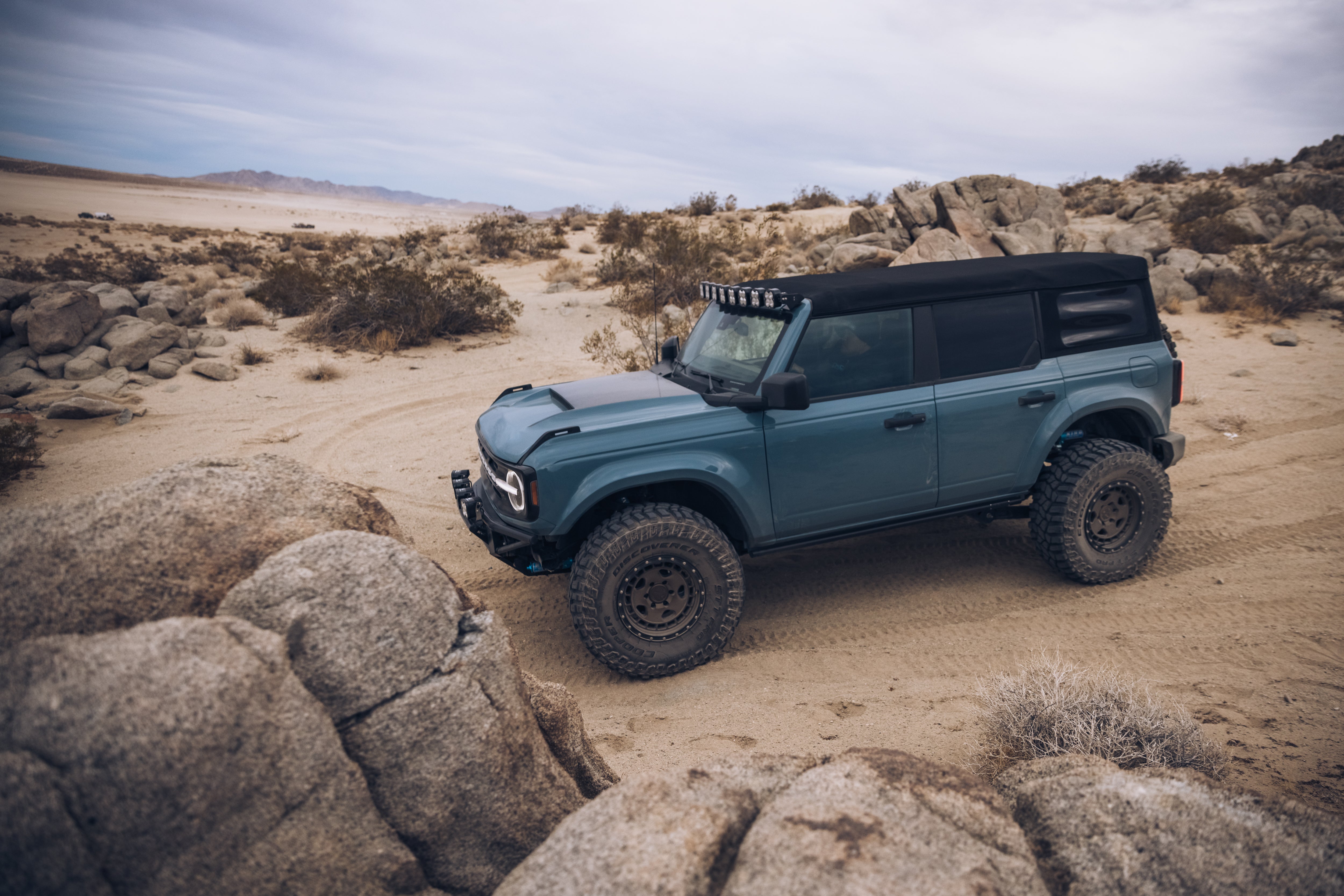 ADV Fiberglass 2021 Ford off-road vehicle on rocky terrain, showcasing rugged design and enhanced performance features.