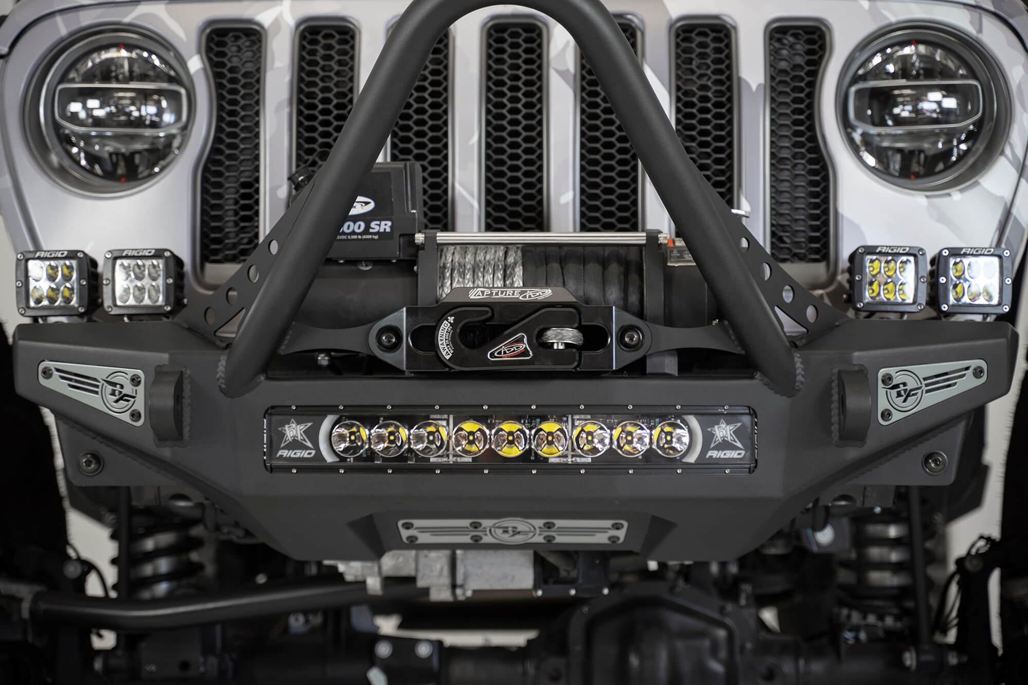 ADD Capture Fairlead in black mounted on a Jeep front bumper, featuring LED lights and a winch for offroad performance.