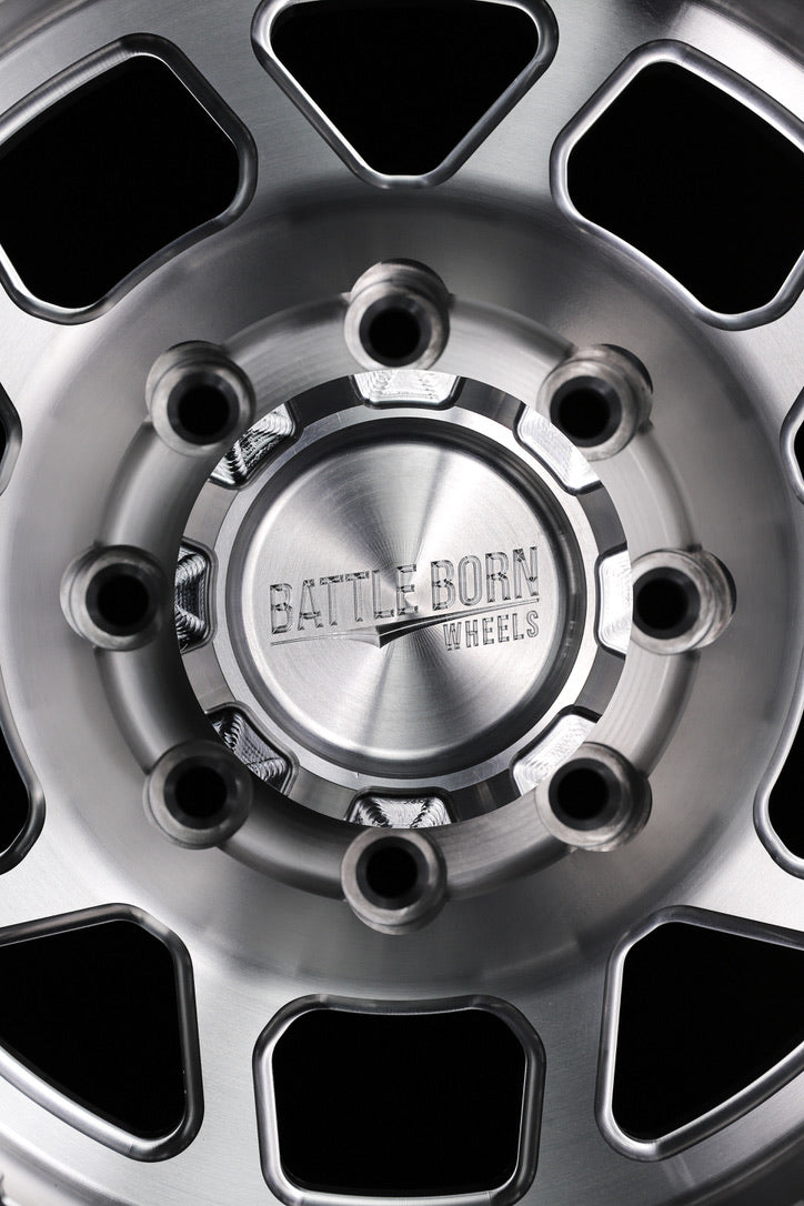 Billet center cap featuring the Battle Born Wheels logo, designed for enhanced style and durability in offroad applications.