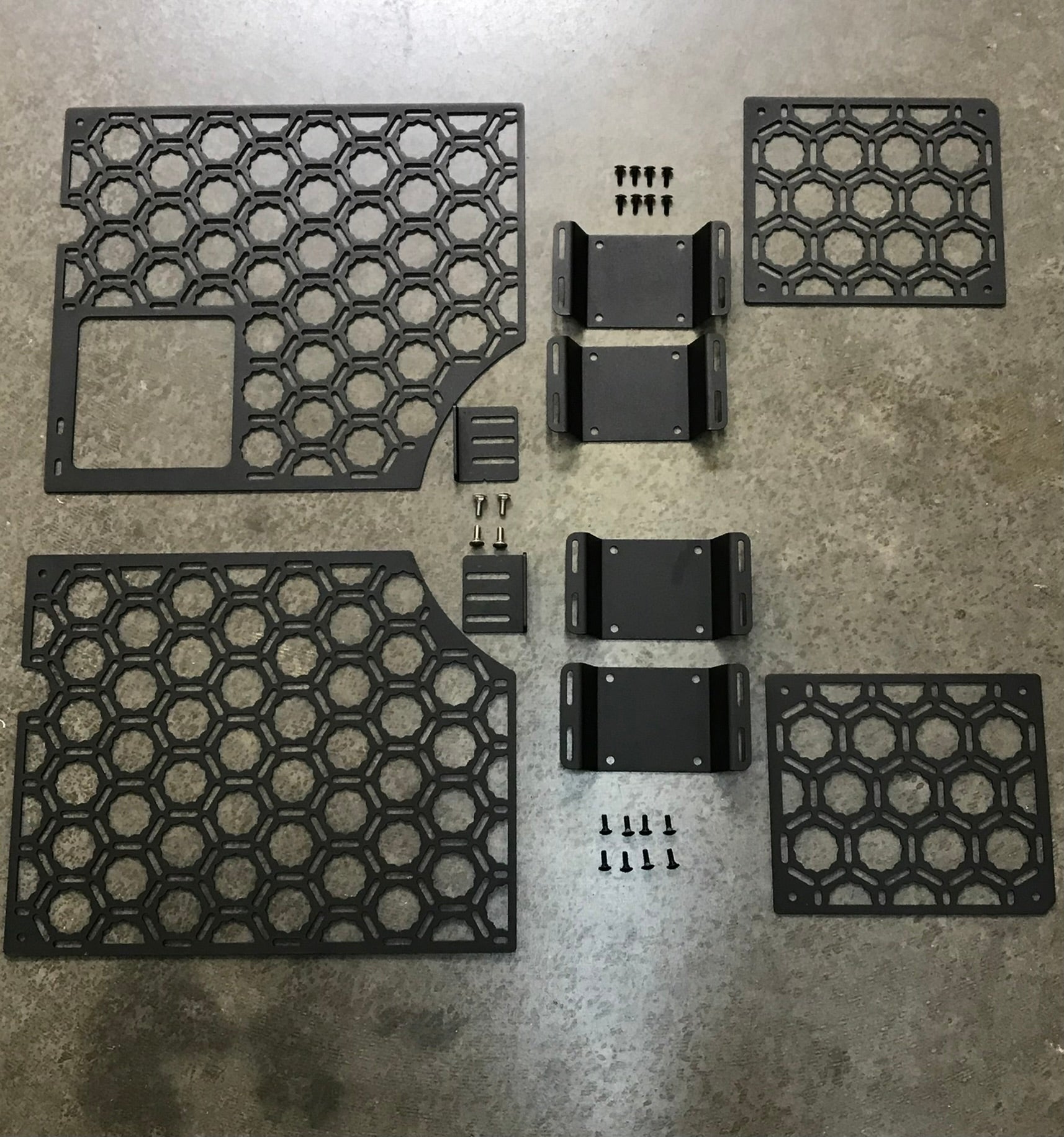 Bedside organizer panel kit for 2021-2023 Ford Raptor and F150, featuring multiple hexagonal panels and mounting hardware.