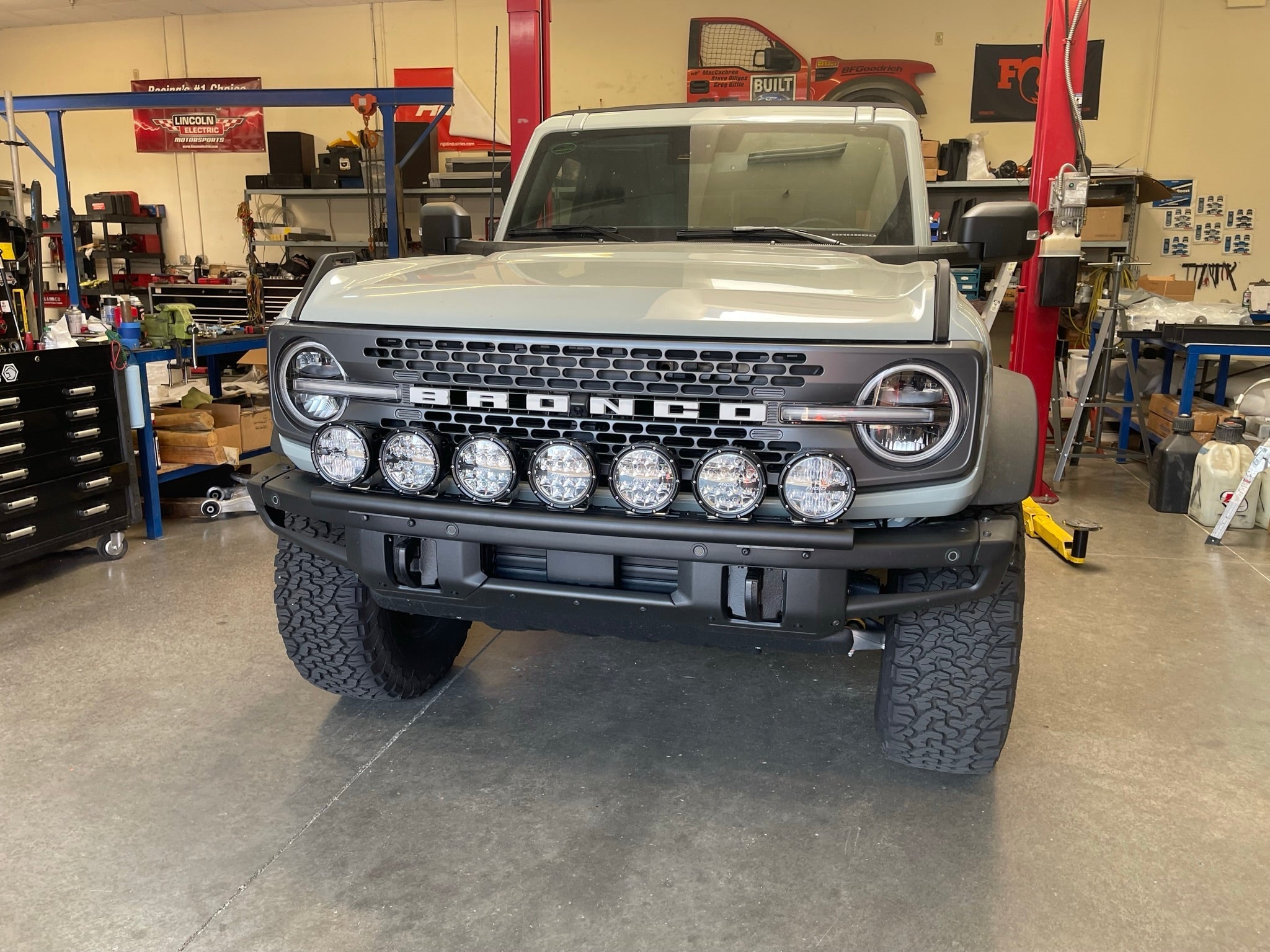 Front view of a 2022-UP Bronco Raptor equipped with a front light mount kit, showcasing multiple light options for offroad use.