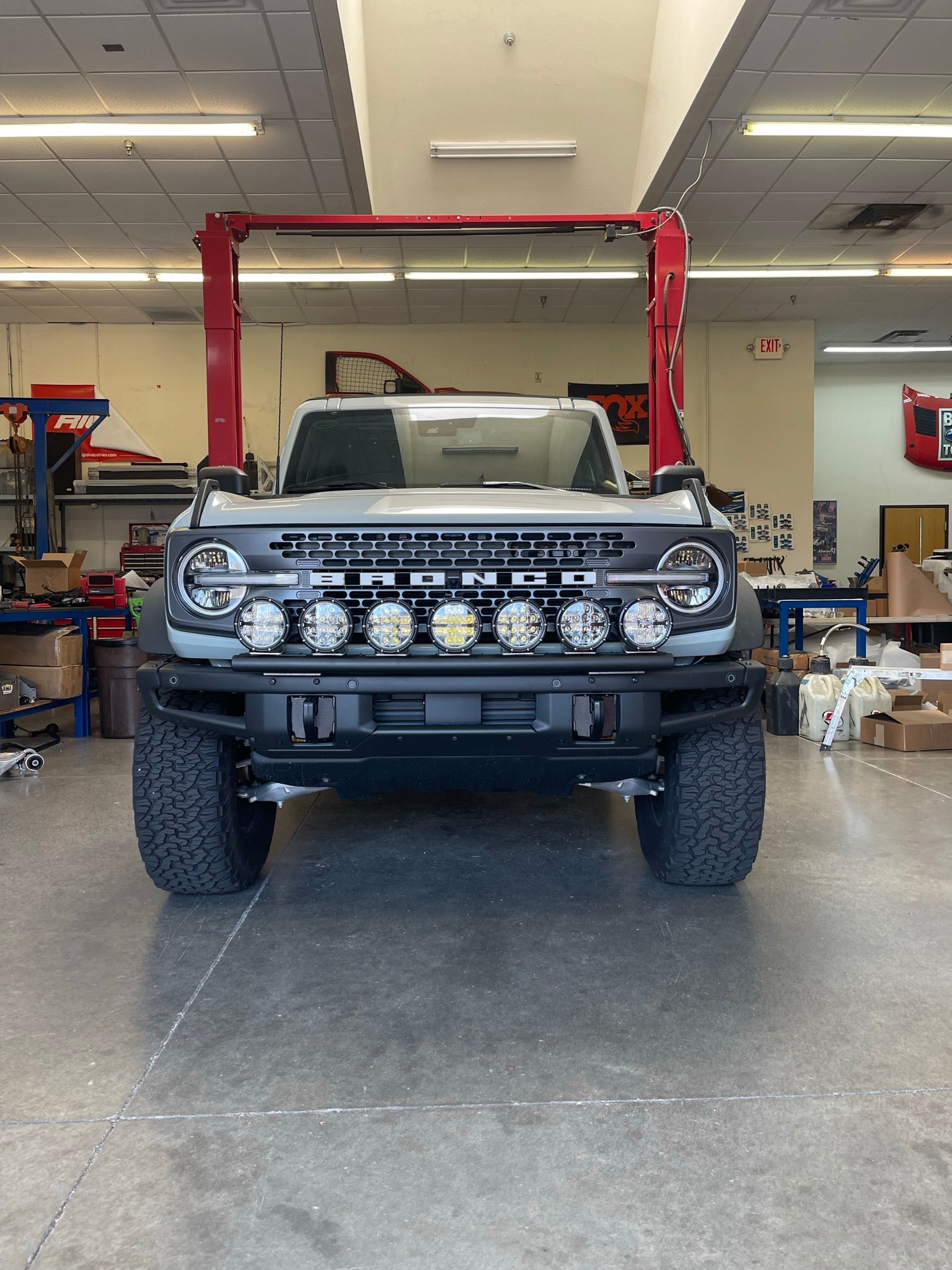 Front view of a 2022-UP Bronco Raptor equipped with a versatile front light mount kit, showcasing various mounted lights.