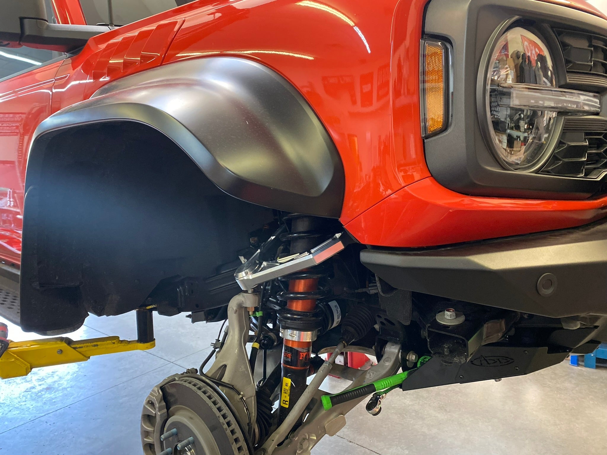 Bronco Raptor Billet Upper Arm Kit installed on a red Bronco, showcasing stock length suspension components.