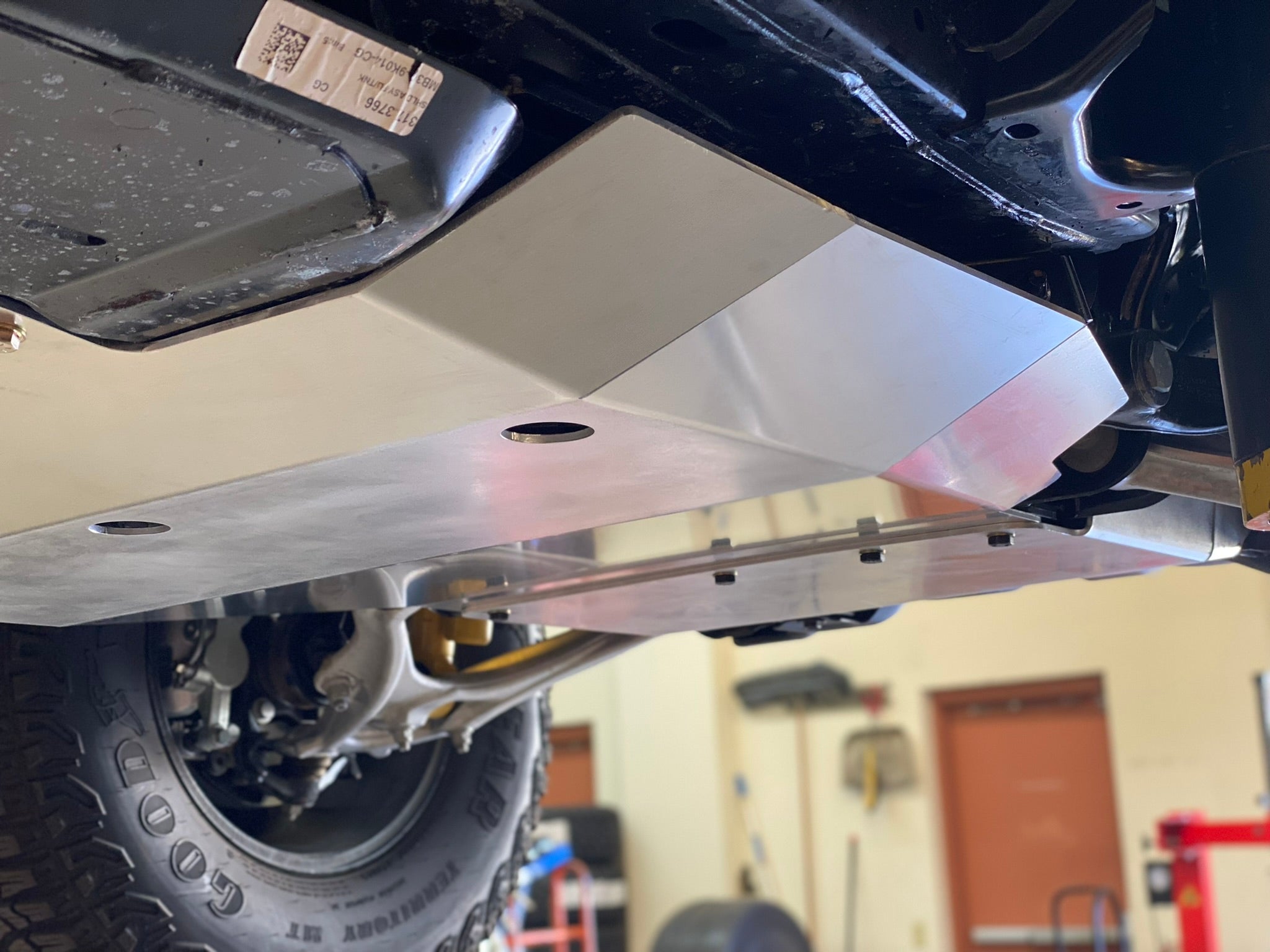 Aluminum skid plate installed on a 2021 Ford Bronco, providing undercarriage protection for off-road adventures.