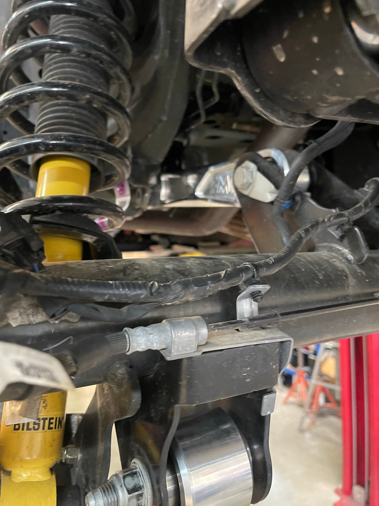 Bronco rear suspension kit featuring billet aluminum rear arms, showcasing detailed components and installation setup.