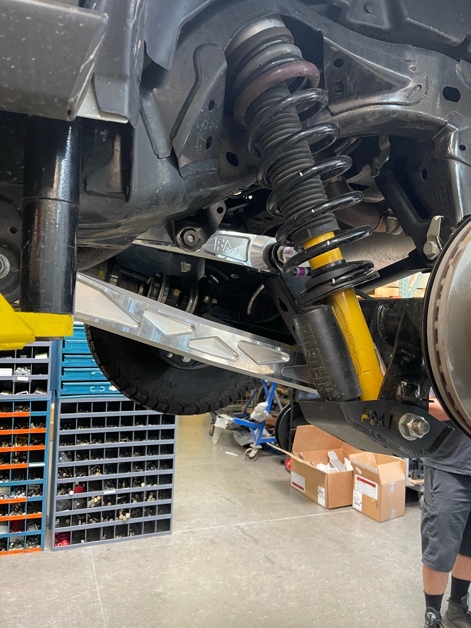 Bronco rear suspension kit featuring billet aluminum rear arms and coilover shock, showcasing offroad performance components.
