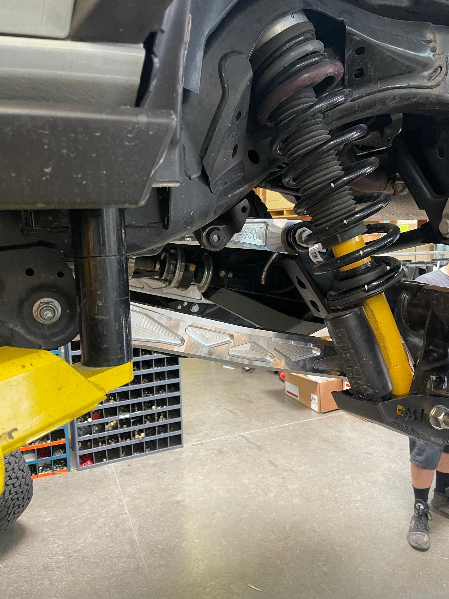 Bronco rear suspension kit featuring billet aluminum rear arms and shock absorbers, showcasing a durable offroad setup.