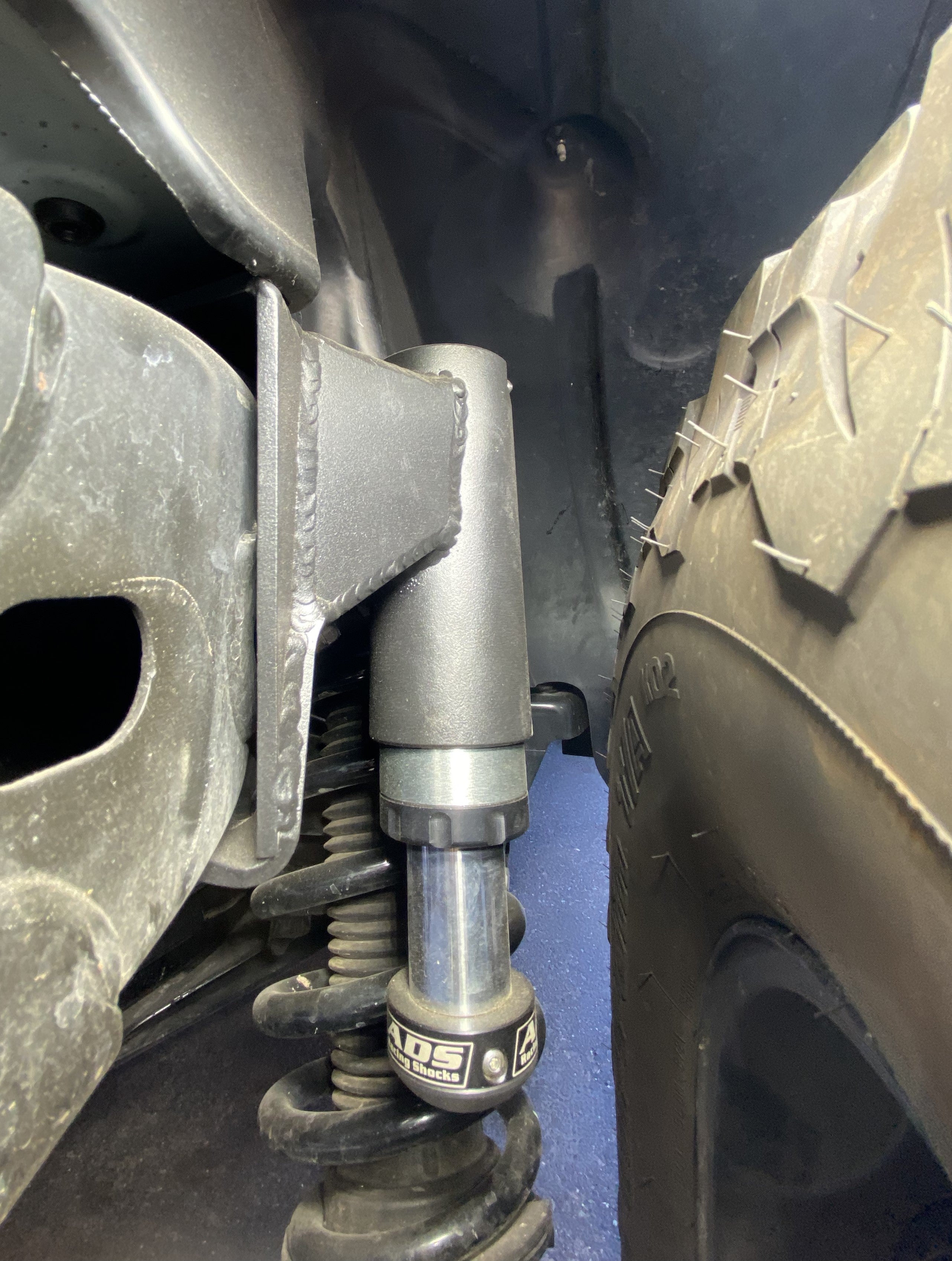 2021 and up Bronco rear hydraulic bump stop kit installed near tire and suspension components.