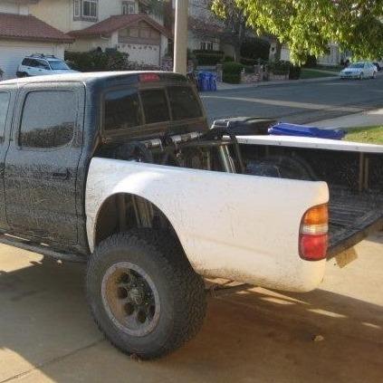 1995-2004 Toyota Tacoma with custom bedsides, showcasing a rugged offroad style and enhanced durability.
