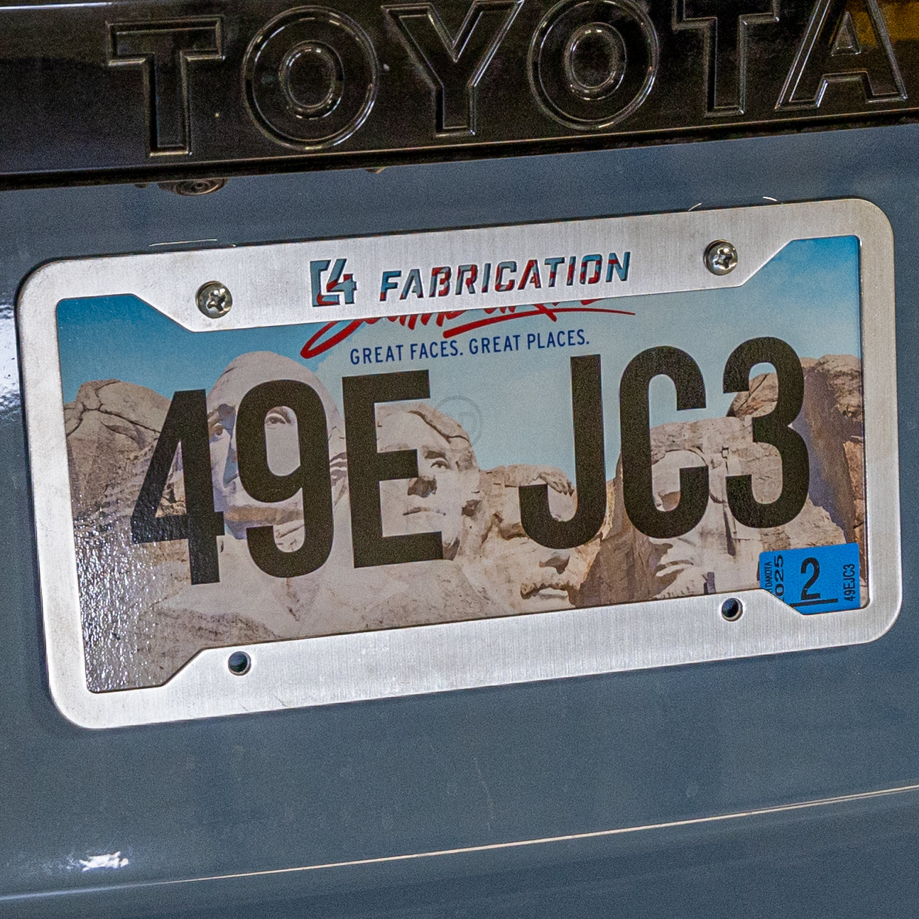 C4 License Plate Frame showcasing a durable metal design, enhancing vehicle aesthetics and protection.