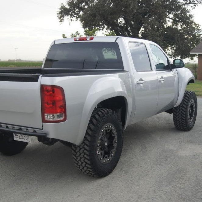 2007-2013 GMC Sierra with custom bedsides and off-road tires, showcasing a rugged and elevated design.