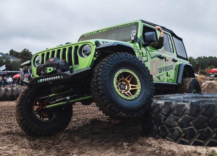 Blaze Front Bumper for Jeep Wrangler JL and Gladiator JT showcased on a modified Jeep navigating rugged terrain.