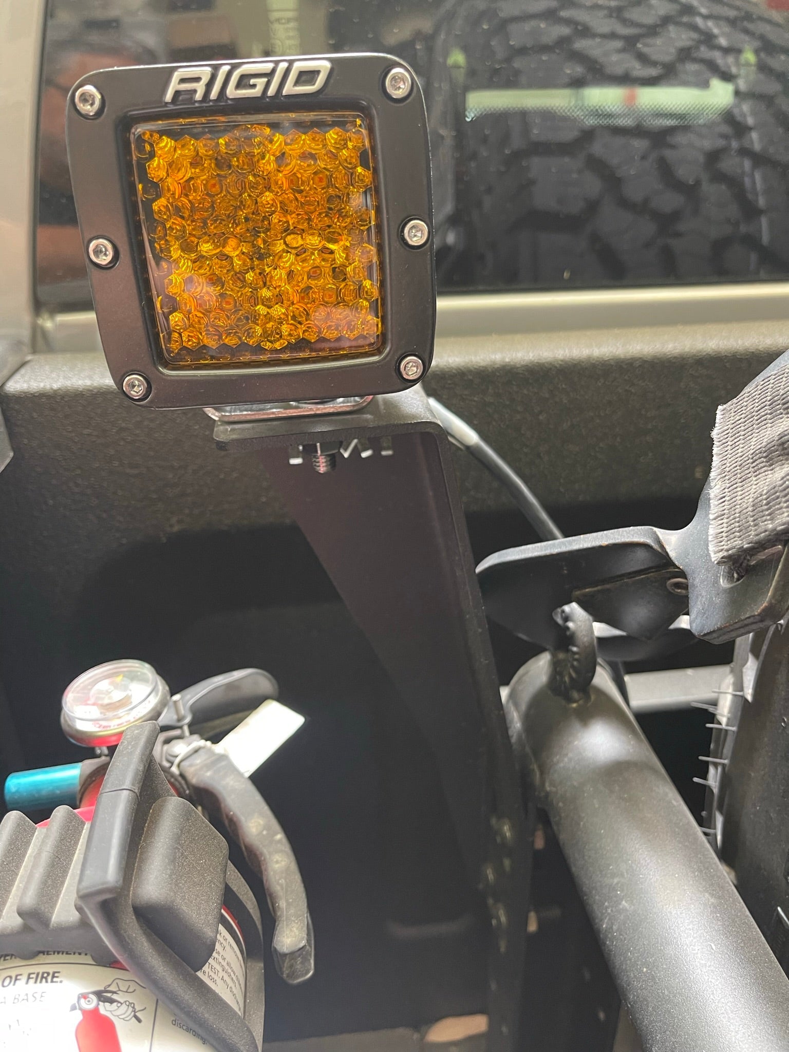 Bed Organizer Chase Rack Add On Light Mount Kit featuring a Rigid amber light mounted securely for offroad visibility.