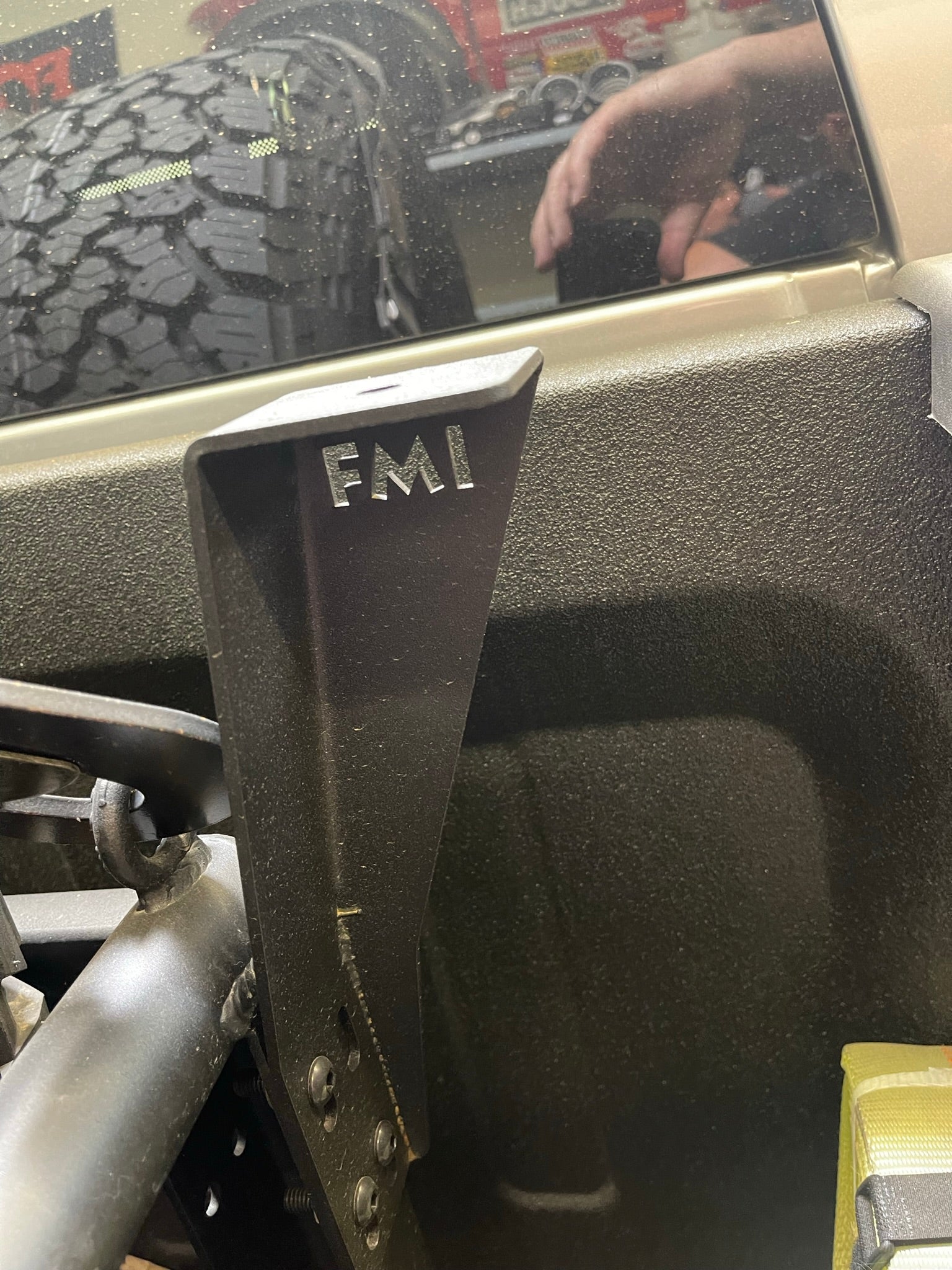 Bed Organizer Chase Rack Add On Light Mount Kit showing a close-up of the mounting bracket with engraved letters and vehicle interior.