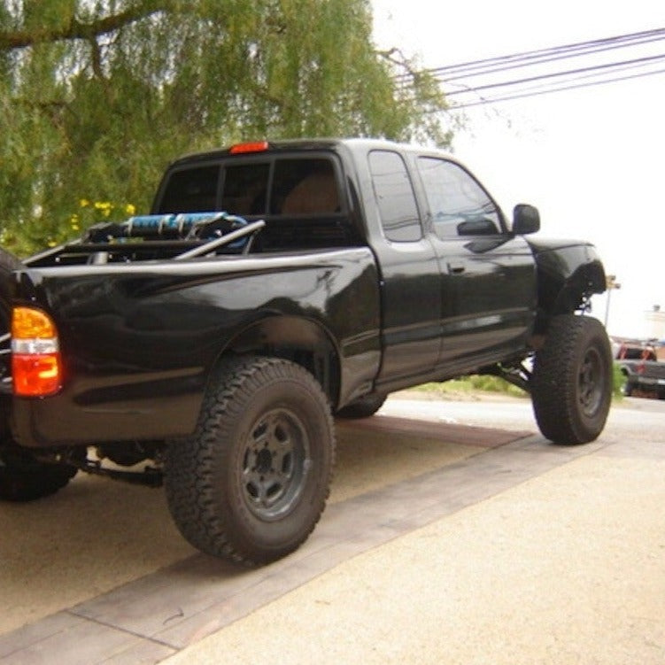 1995-2004 Toyota Tacoma bedsides installed on a lifted black pickup truck showcasing offroad capabilities.