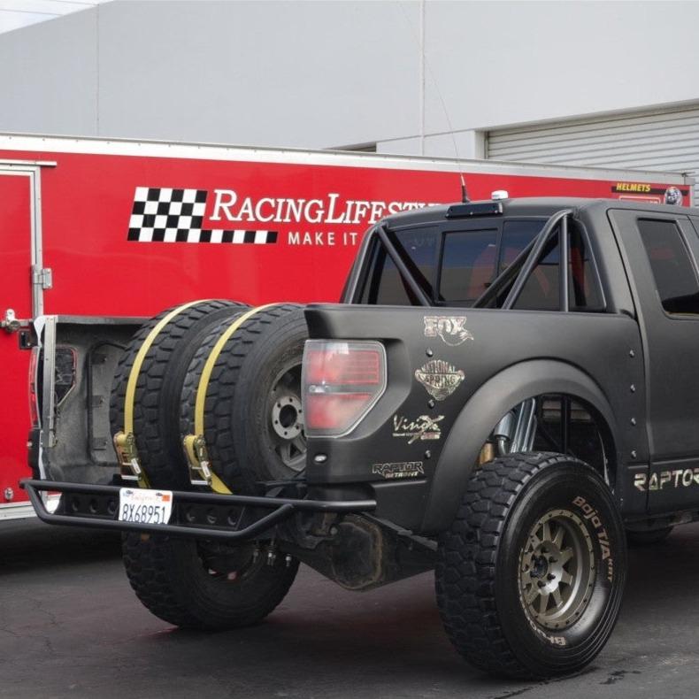 Custom 2010-2016 Ford Raptor with aftermarket bedsides and offroad tires, showcasing rugged design and performance.