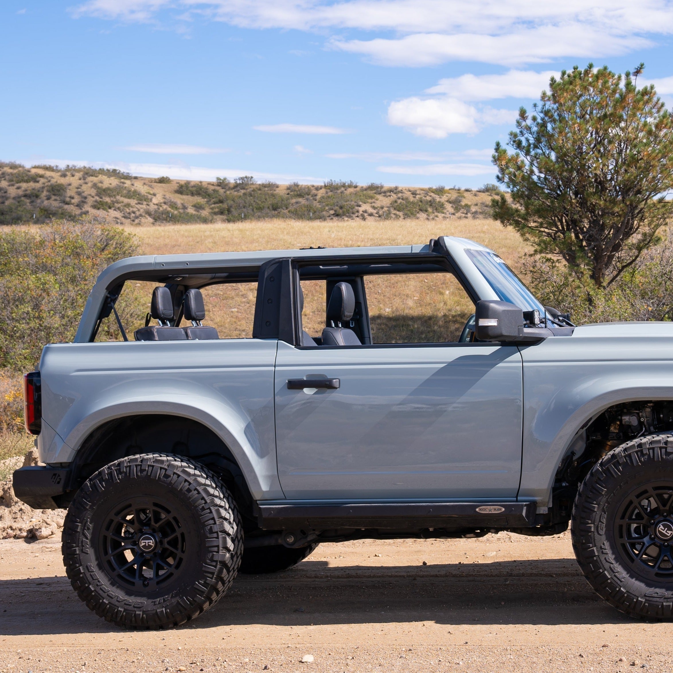 2021-2025 Ford Bronco 2-Door Rear Quarter Kit showcasing a rugged off-road vehicle in a natural landscape.