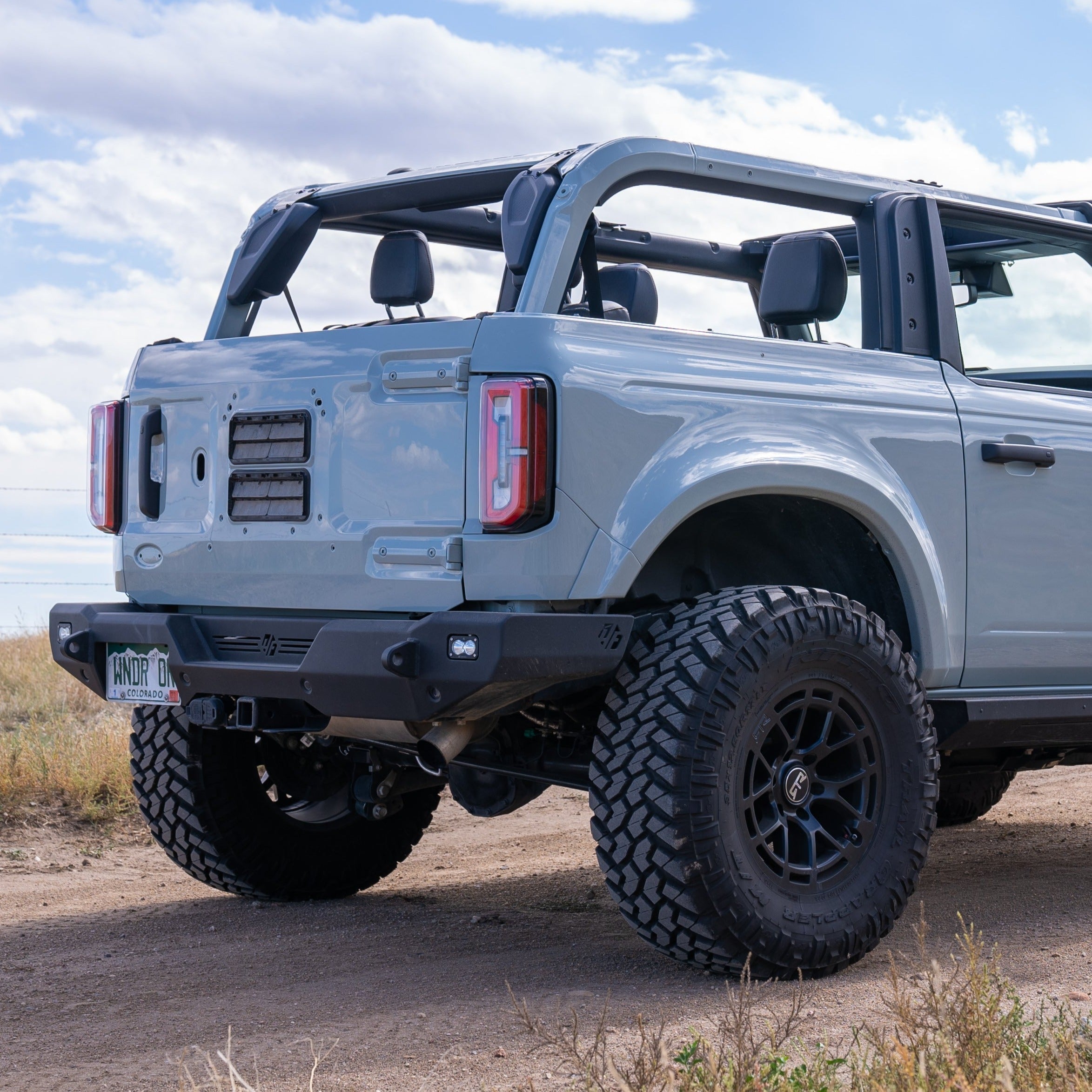 Rear view of a 2021-2025 Ford Bronco 2-Door showcasing the rear quarter kit, highlighting rugged tires and offroad design.