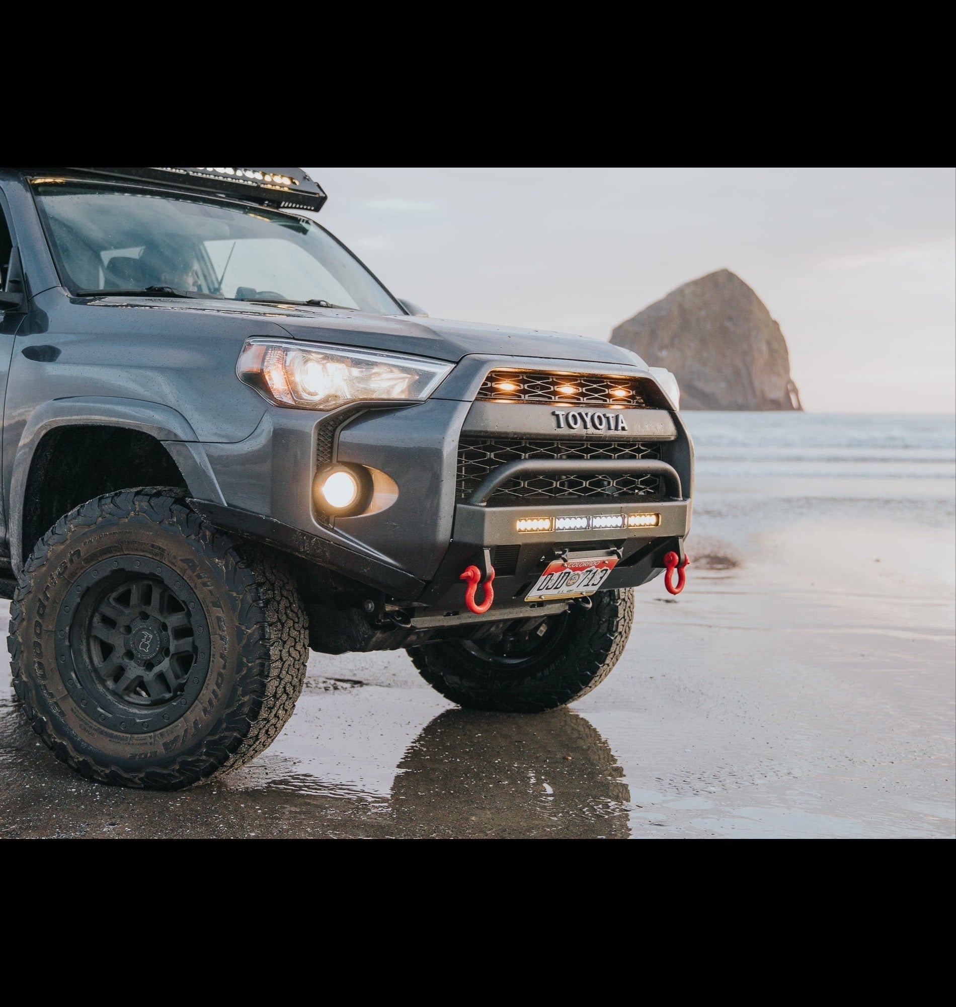 High clearance Lo Pro bumper for 2014-2024 Toyota 4Runner, showcasing rugged design and off-road readiness on the beach.