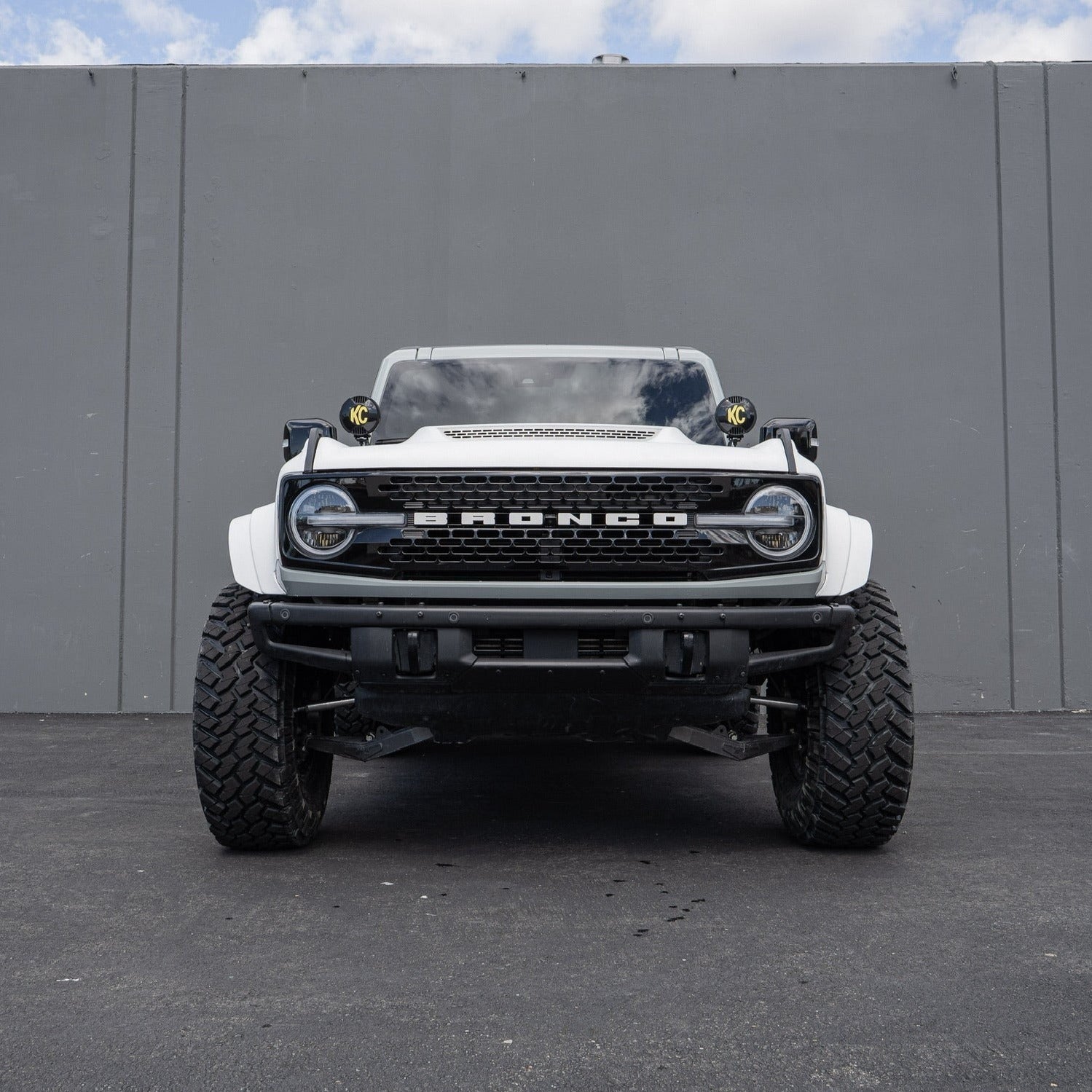 2021-2025 Ford Bronco fenders displayed on a modified white Bronco with offroad tires and lights.