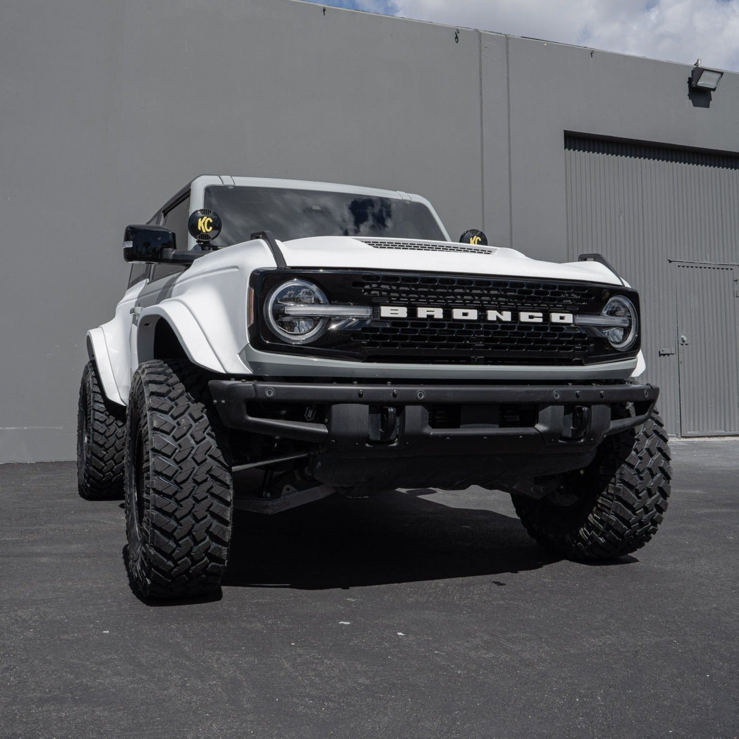 2021-2025 Ford Bronco with aftermarket fenders and rugged tires, showcasing an aggressive off-road design.