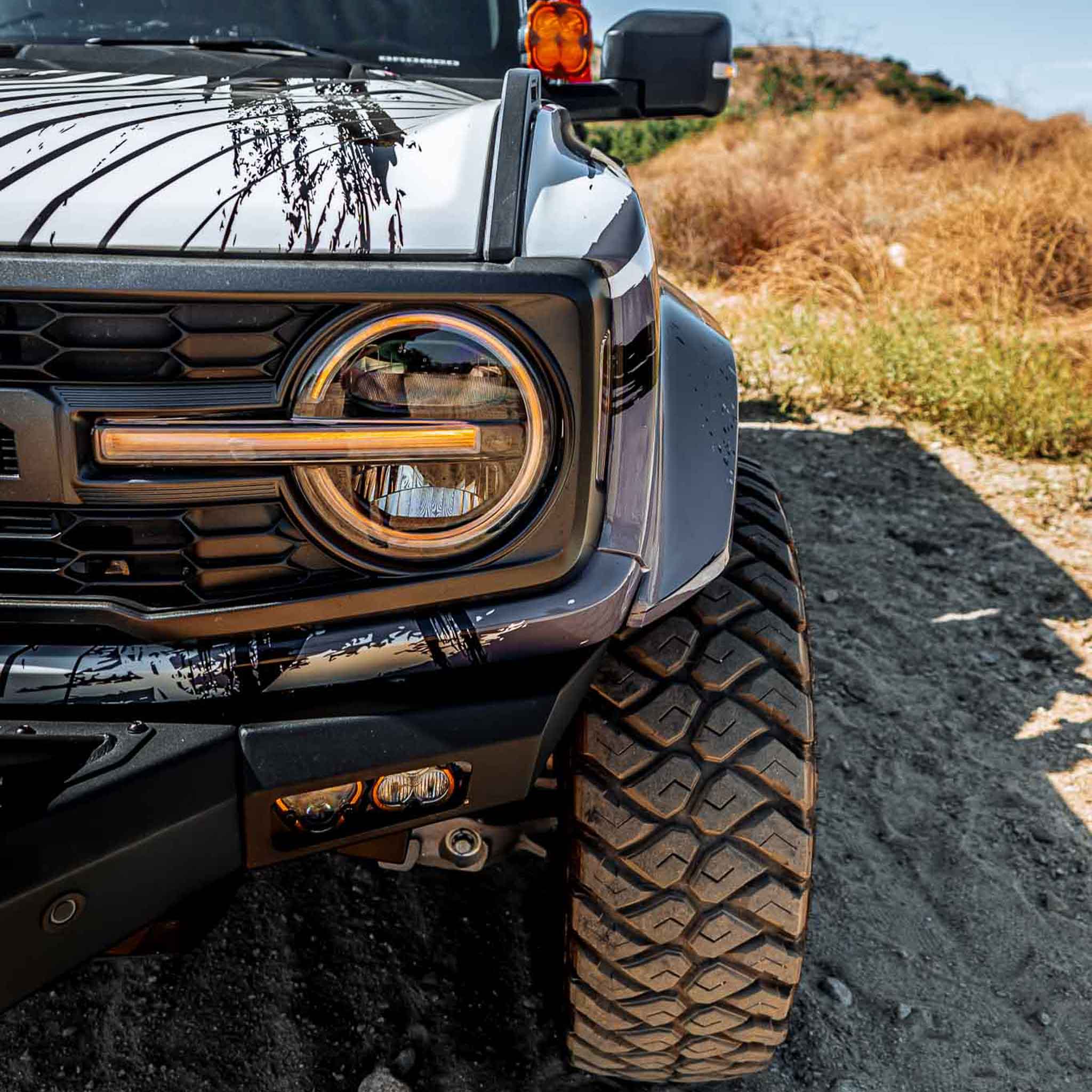 2022-2025 Ford Bronco Raptor fenders showcasing rugged design and enhanced off-road capability on a gravel surface.