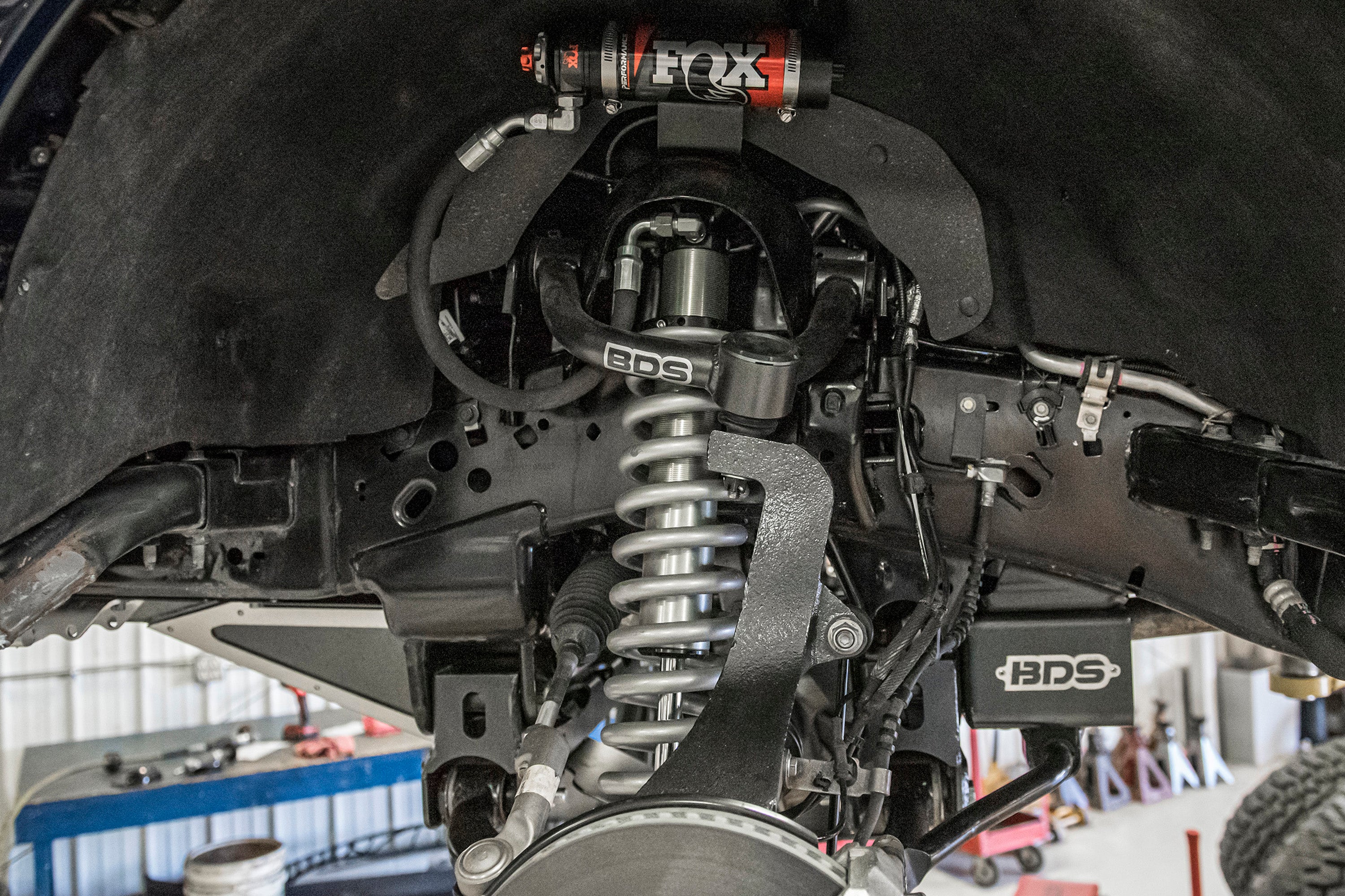 6 inch lift kit installed on a Ford F150 4WD, showcasing suspension components and shock absorber details.