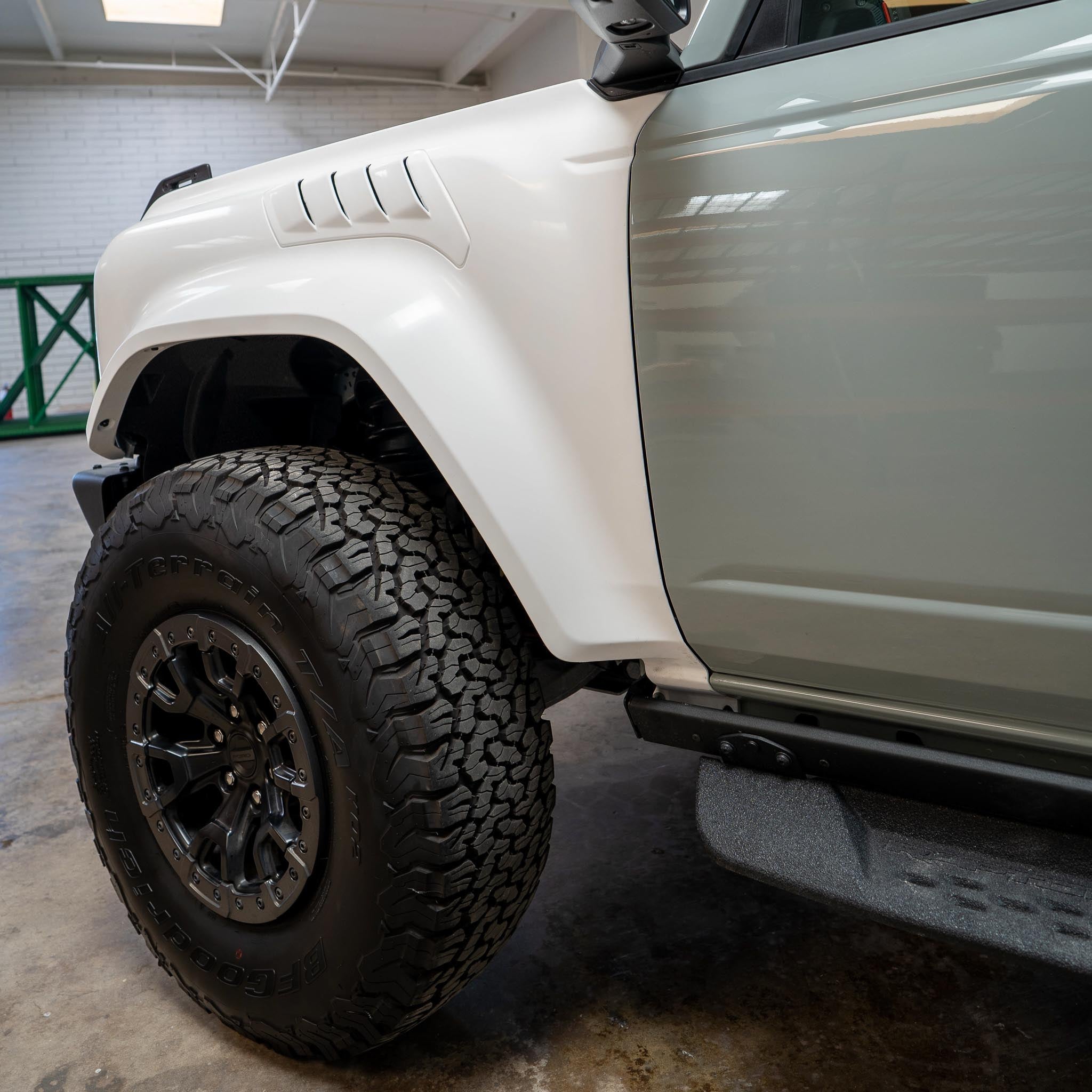 2022-2025 Ford Bronco Raptor fenders showcasing a rugged design with off-road tires for enhanced performance.