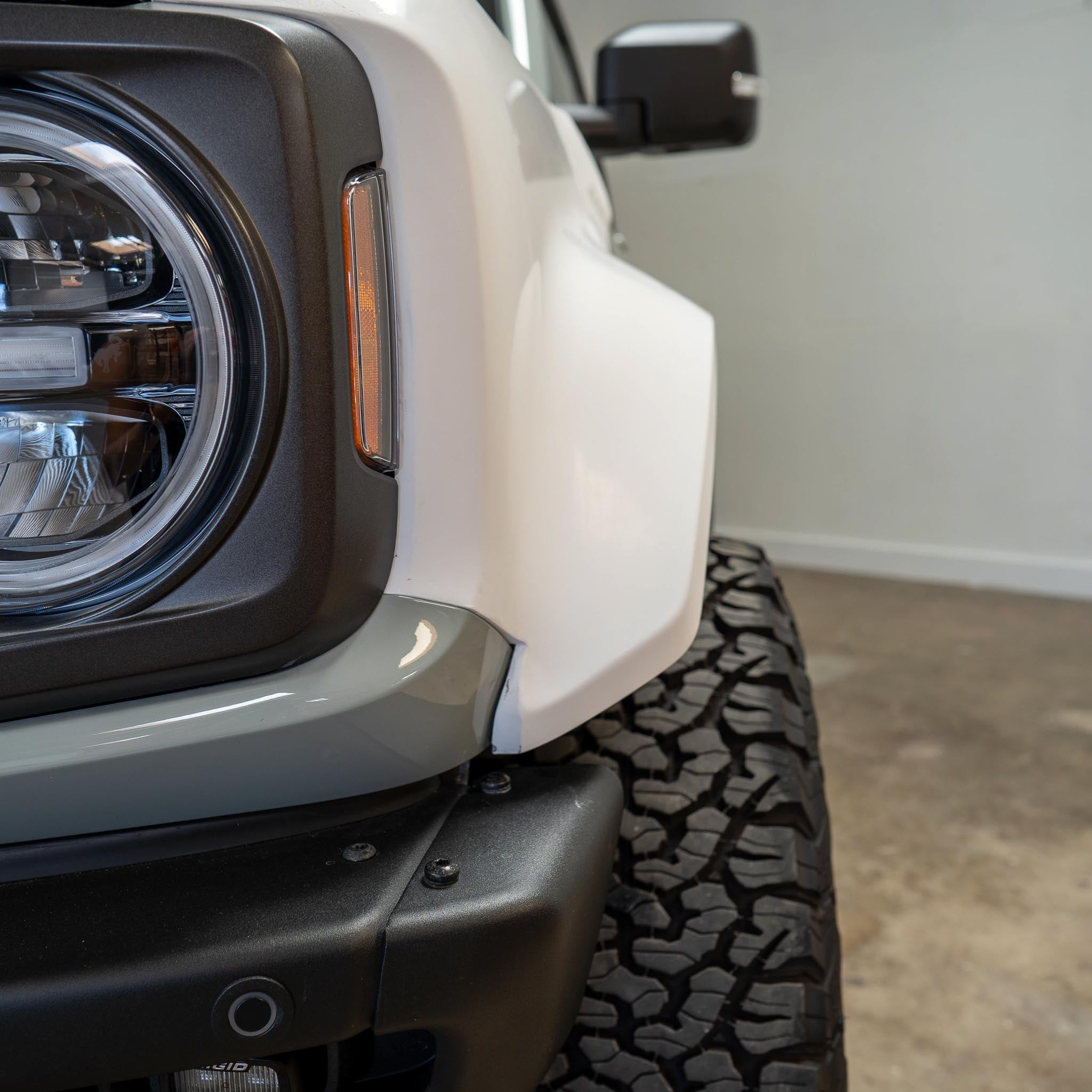 2022-2025 Ford Bronco Raptor fenders showcasing a close-up view of the front design and rugged tire tread.