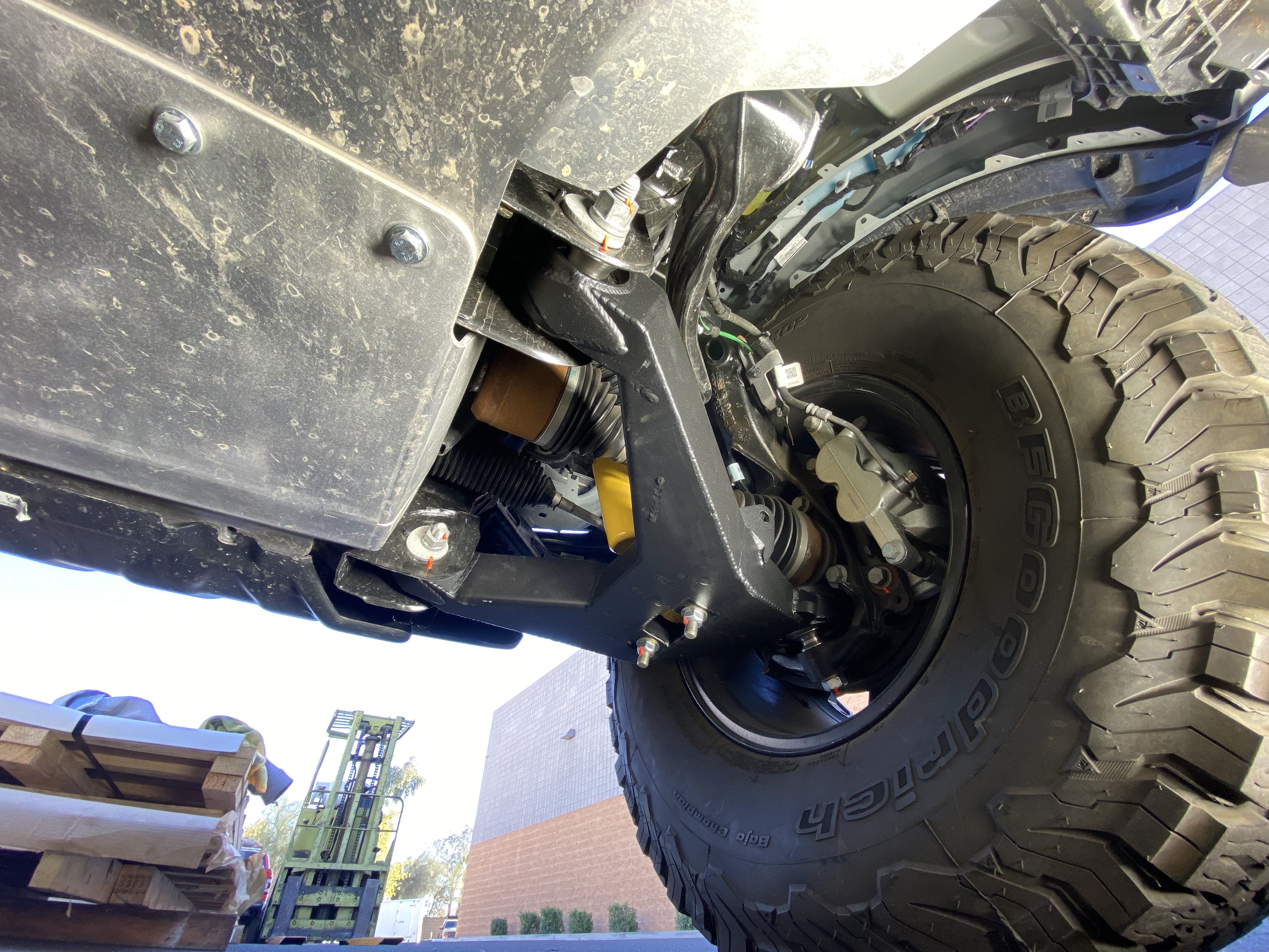 2021 and up Bronco fabricated lower arm kit with bypass shock mount installed, showcasing stock length and rugged design.