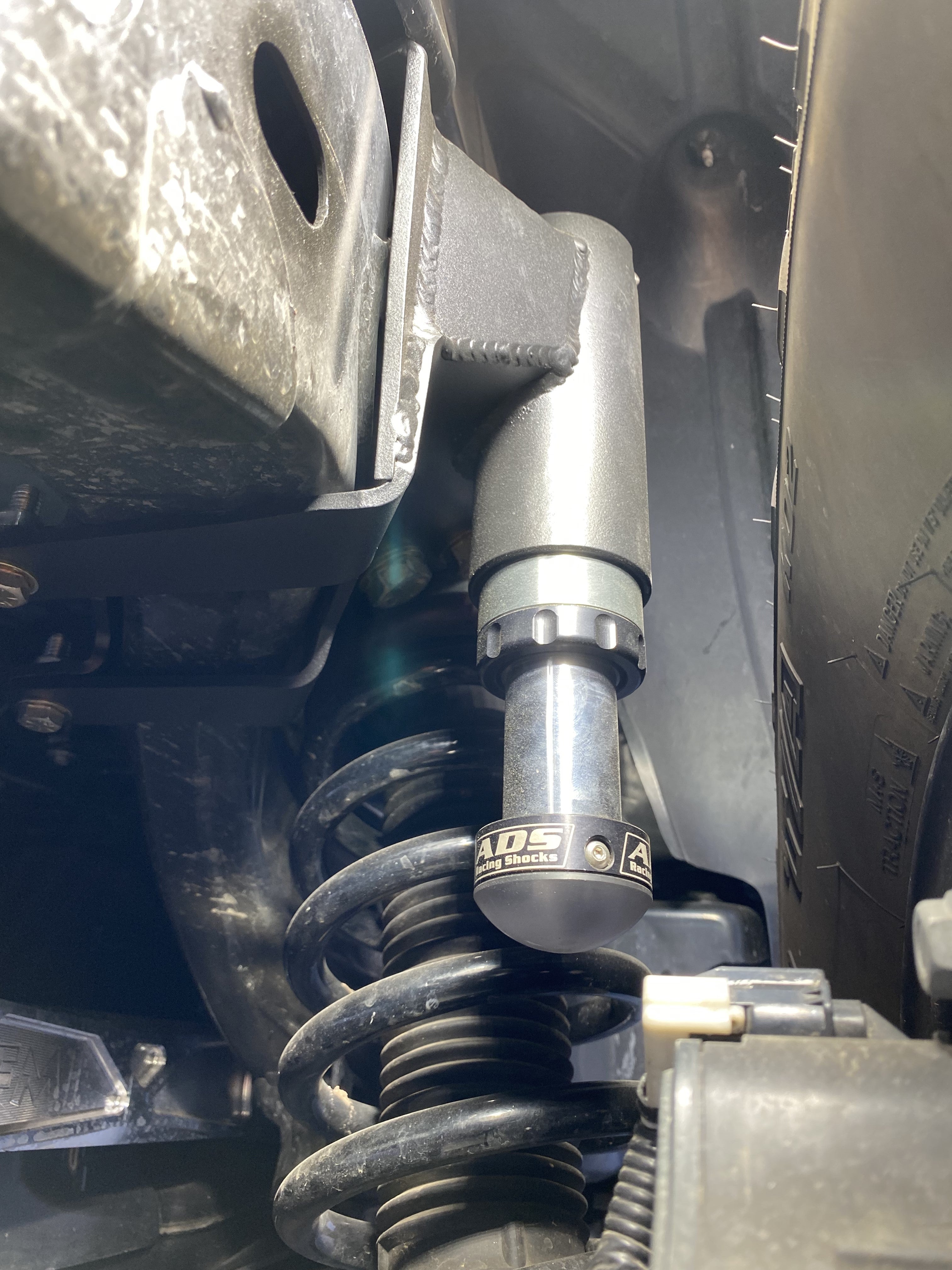 2021 and up Bronco rear hydraulic bump stop kit installed, showcasing the component's design and placement within the suspension system.