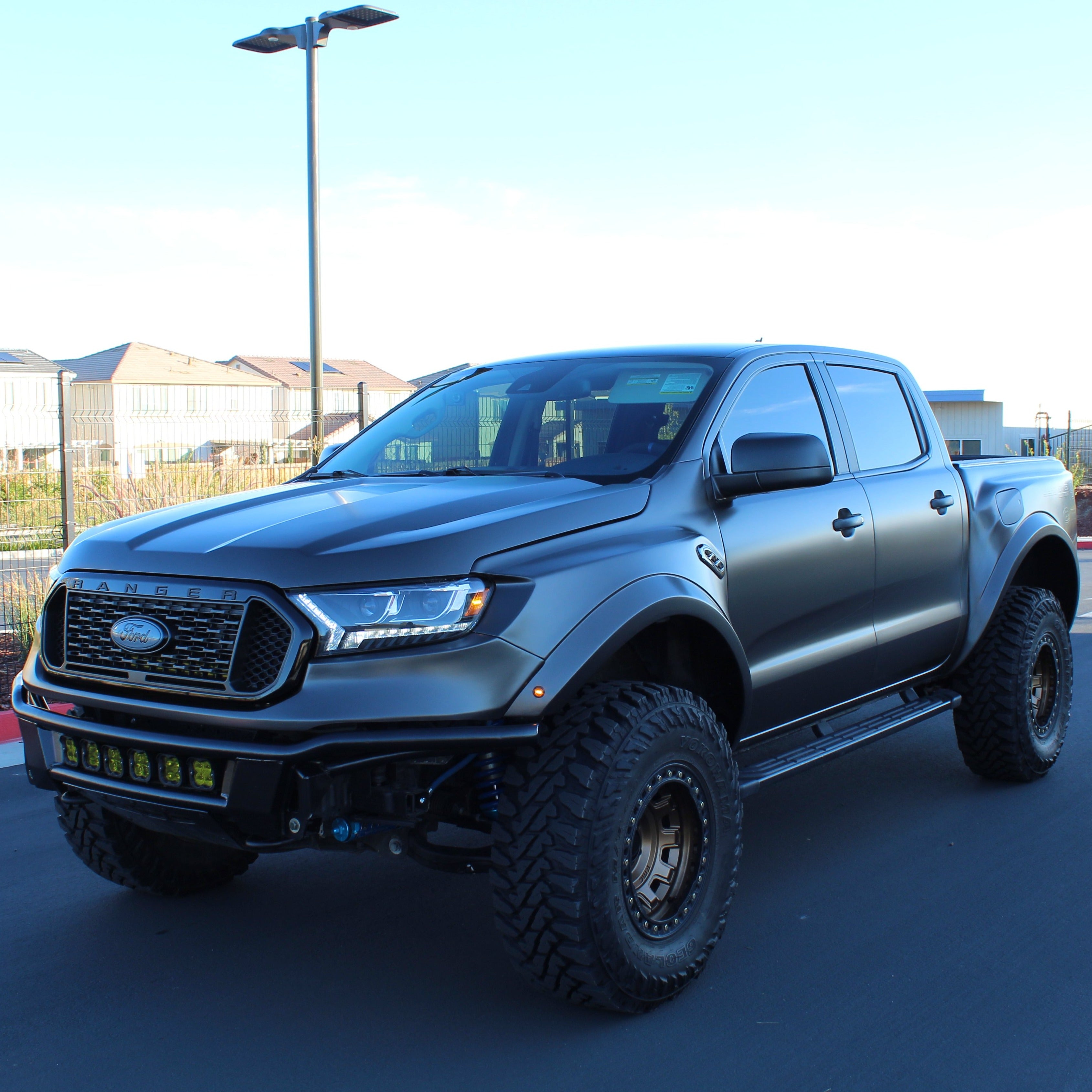 2019-2023 Ford Ranger with custom bedsides, showcasing an aggressive offroad design and rugged tires.