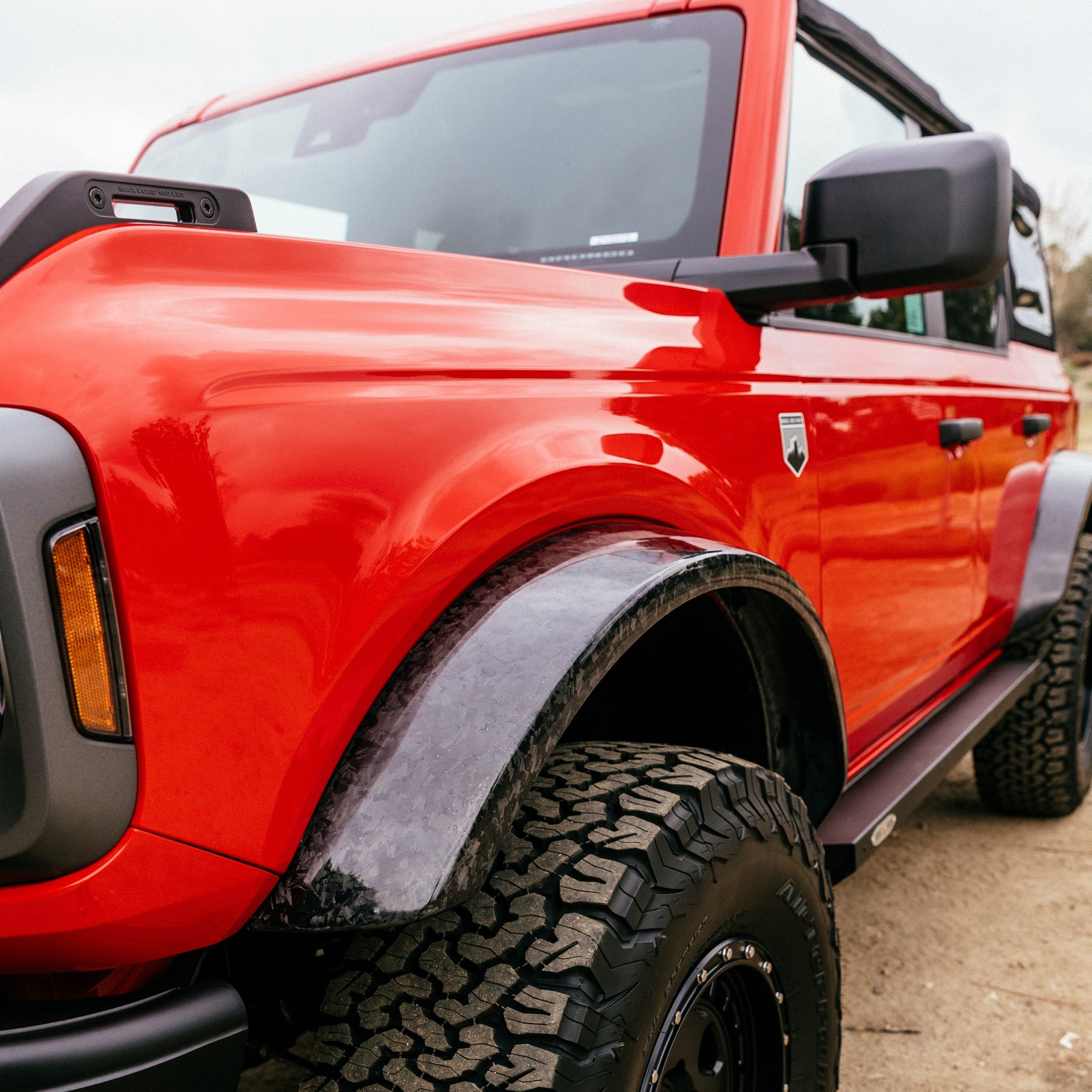 2021-2025 Ford Bronco Sasquatch Flares showcasing a rugged design on a red Bronco with off-road tires.