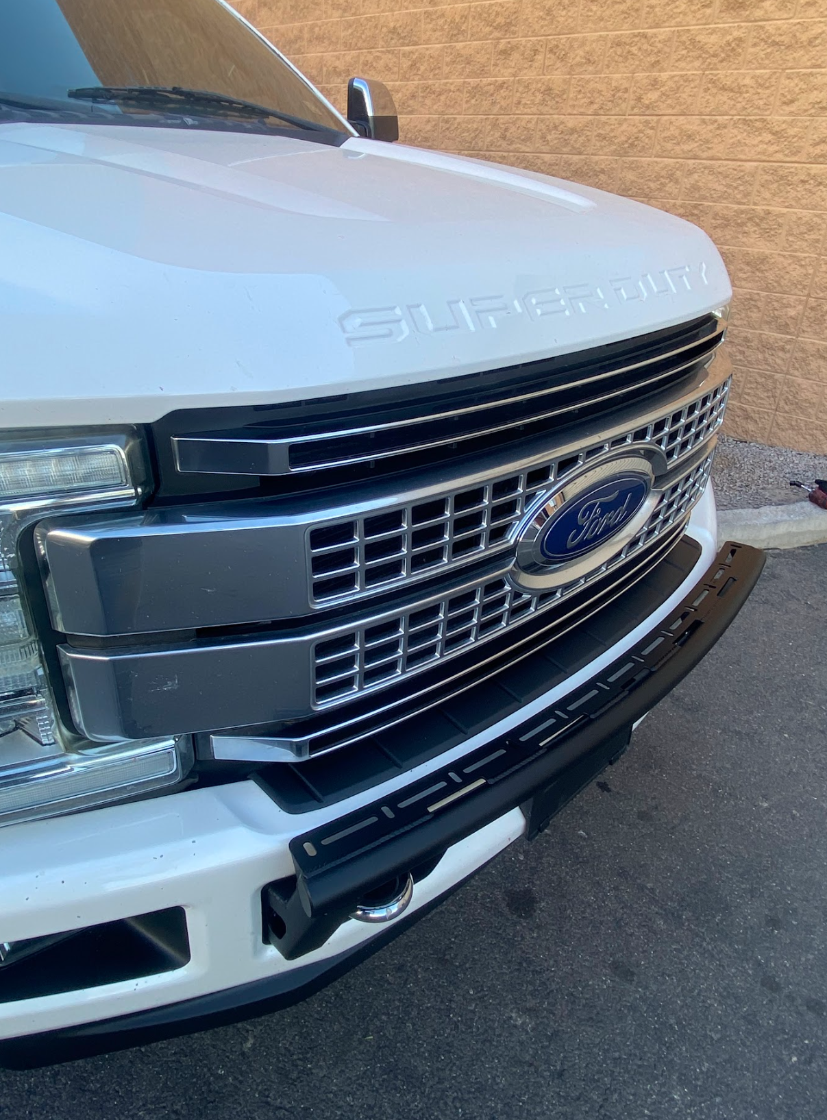 Front view of a 2017-2022 Ford F-250 Super Duty showcasing the Foutz Motorsports Front Light Mount Kit on a stock bumper.
